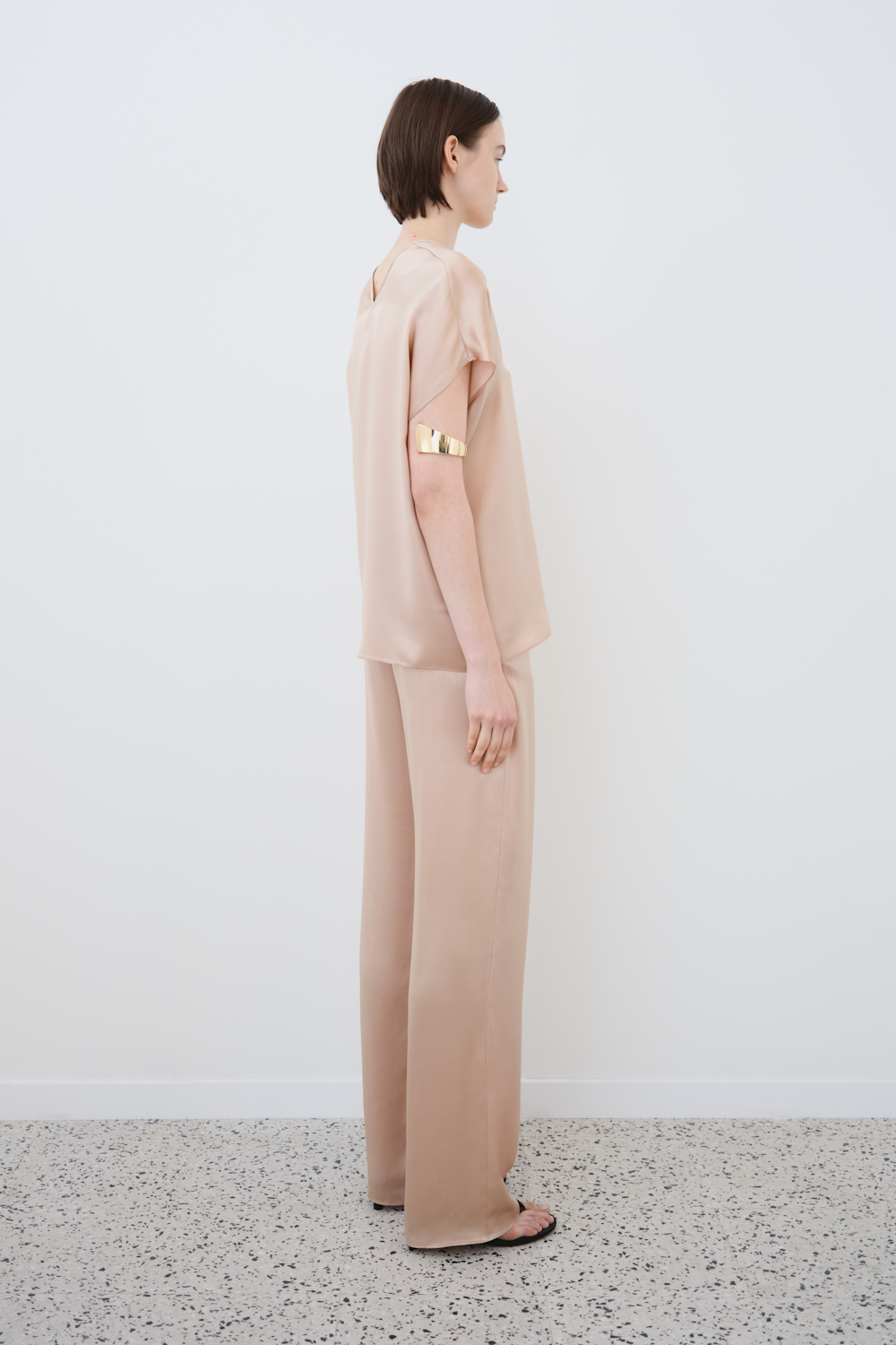Side profile of the Cleo top and James trousers in Sand — sustainable womenswear silk tailoring with fluid lines and modern proportions by HERTH.