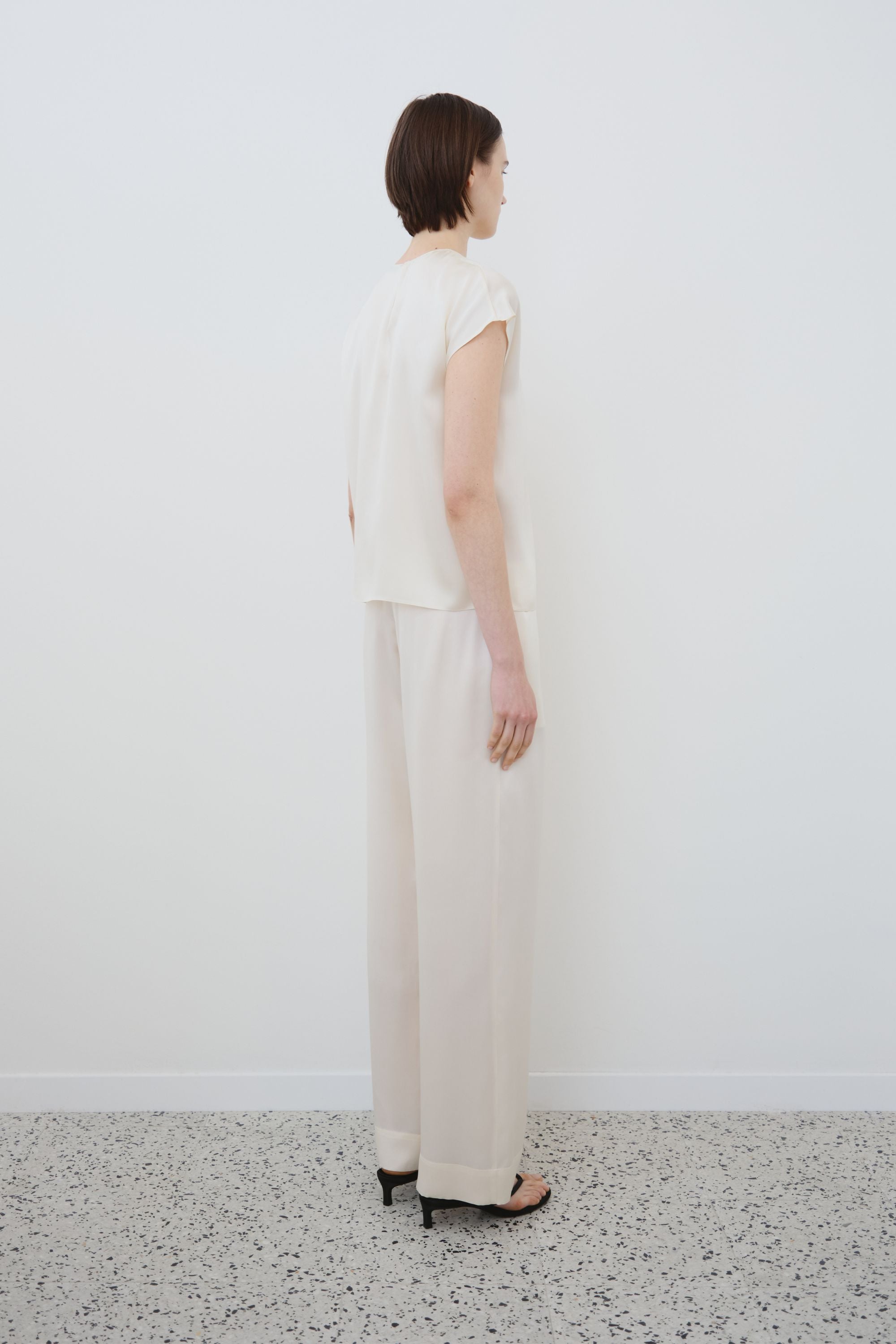 Back view of organic silk top and trousers set in almond, Cora top and Zeno trousers made in Italy