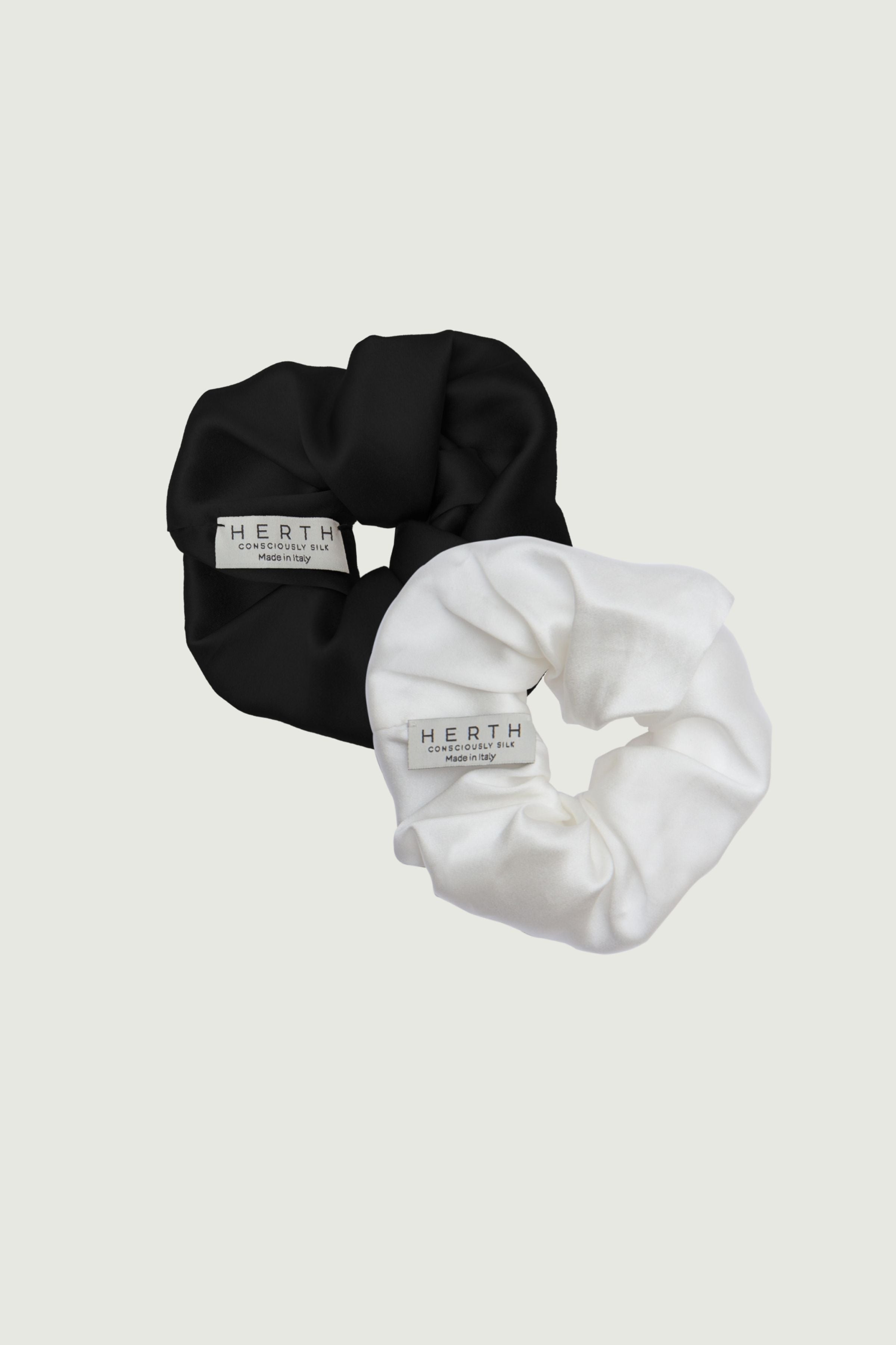 Silk scrunchies set in black and ivory, two hair ties shown together