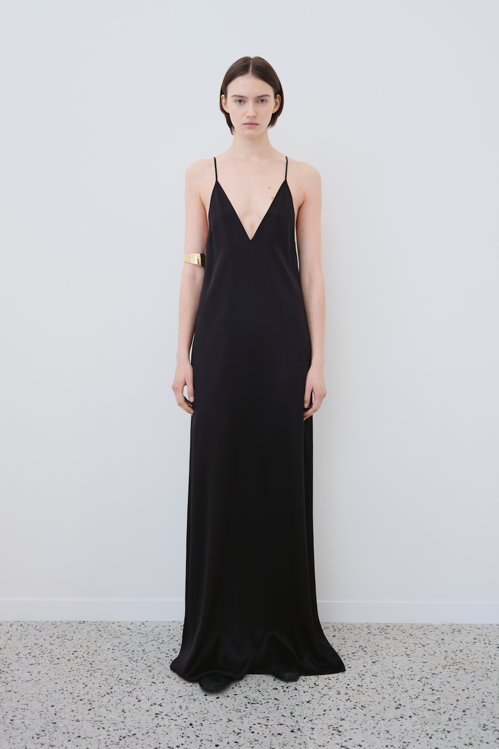 Front view of the INEZ slip dress in black GOTS-certified organic silk — sleek, sustainable womenswear featuring a V-neckline and fluid drape by HERTH.