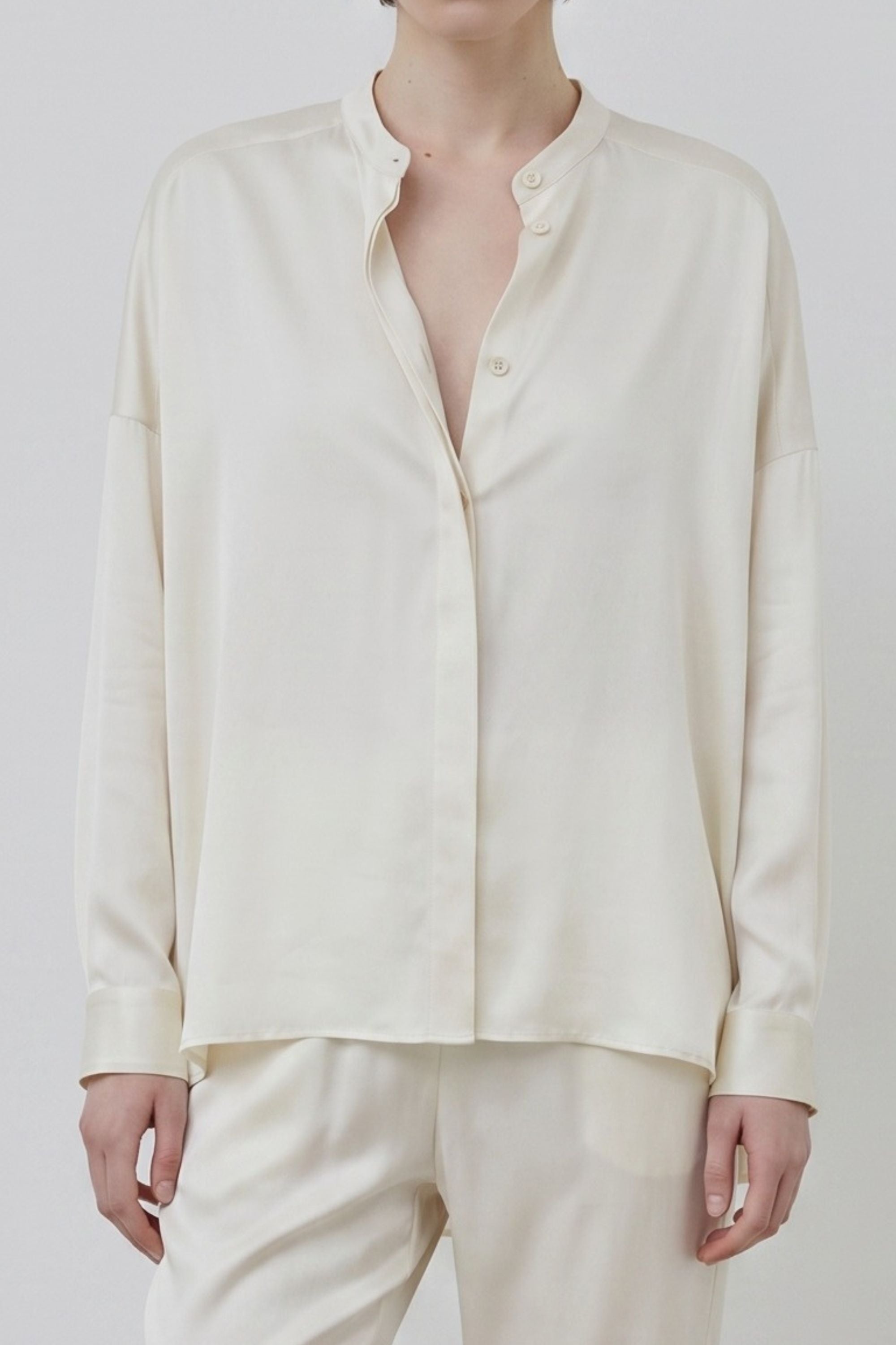 Ivory organic silk shirt detail, fluid texture and soft drape, crafted in Italy