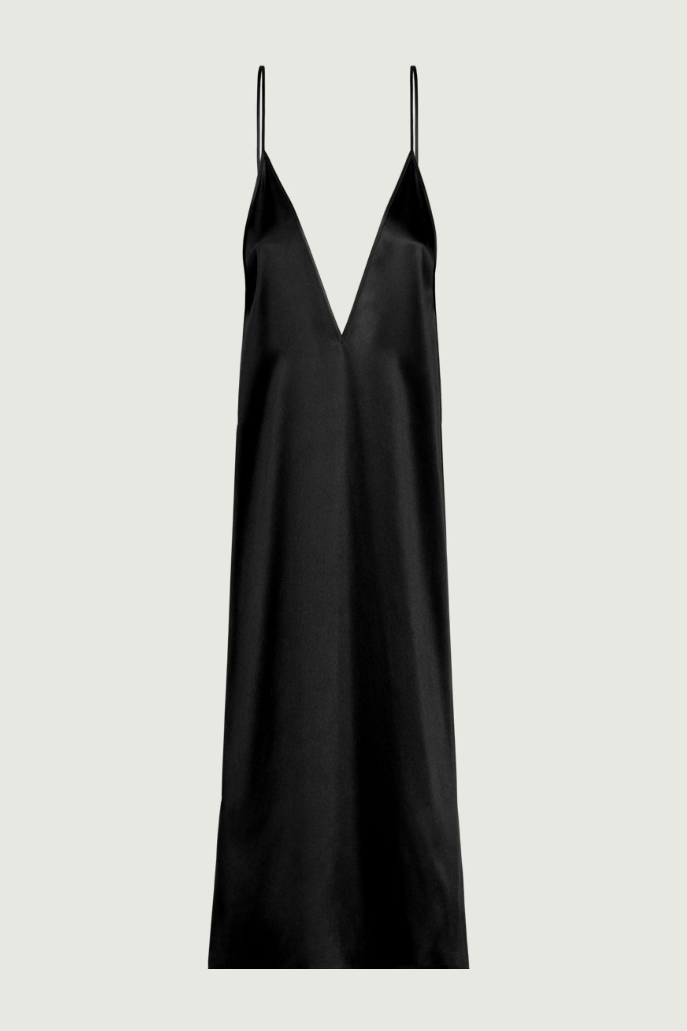 Black silk slip dress with deep V neckline and elongated silhouette, front view emphasizing clean structure and evening elegance