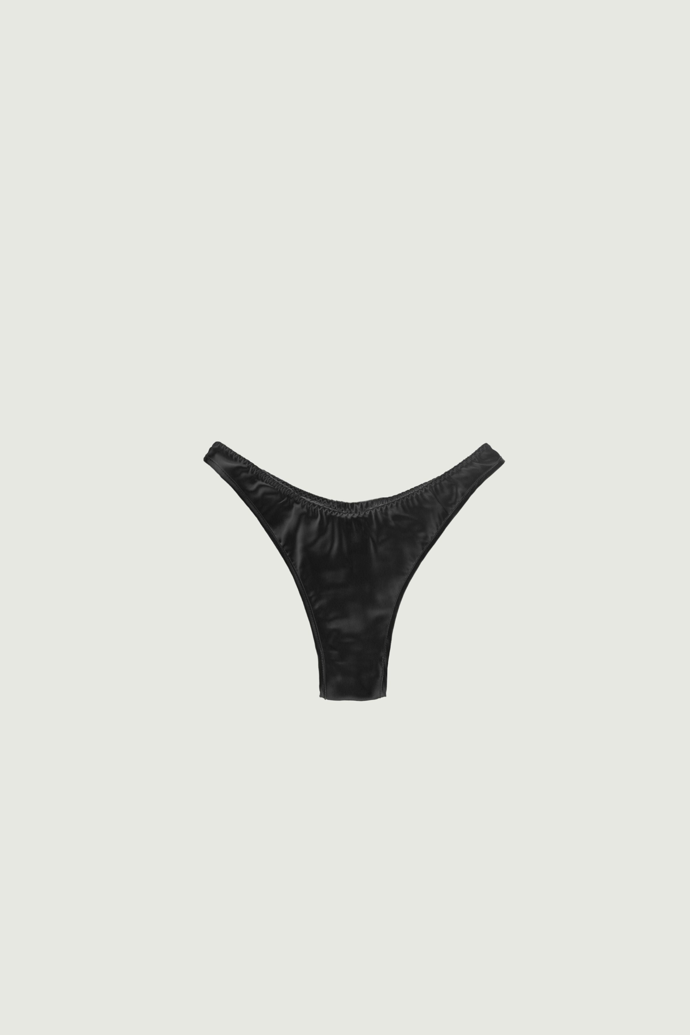 Black silk high-cut panty with minimal coverage, front view highlighting high-cut leg and sleek streamlined shape