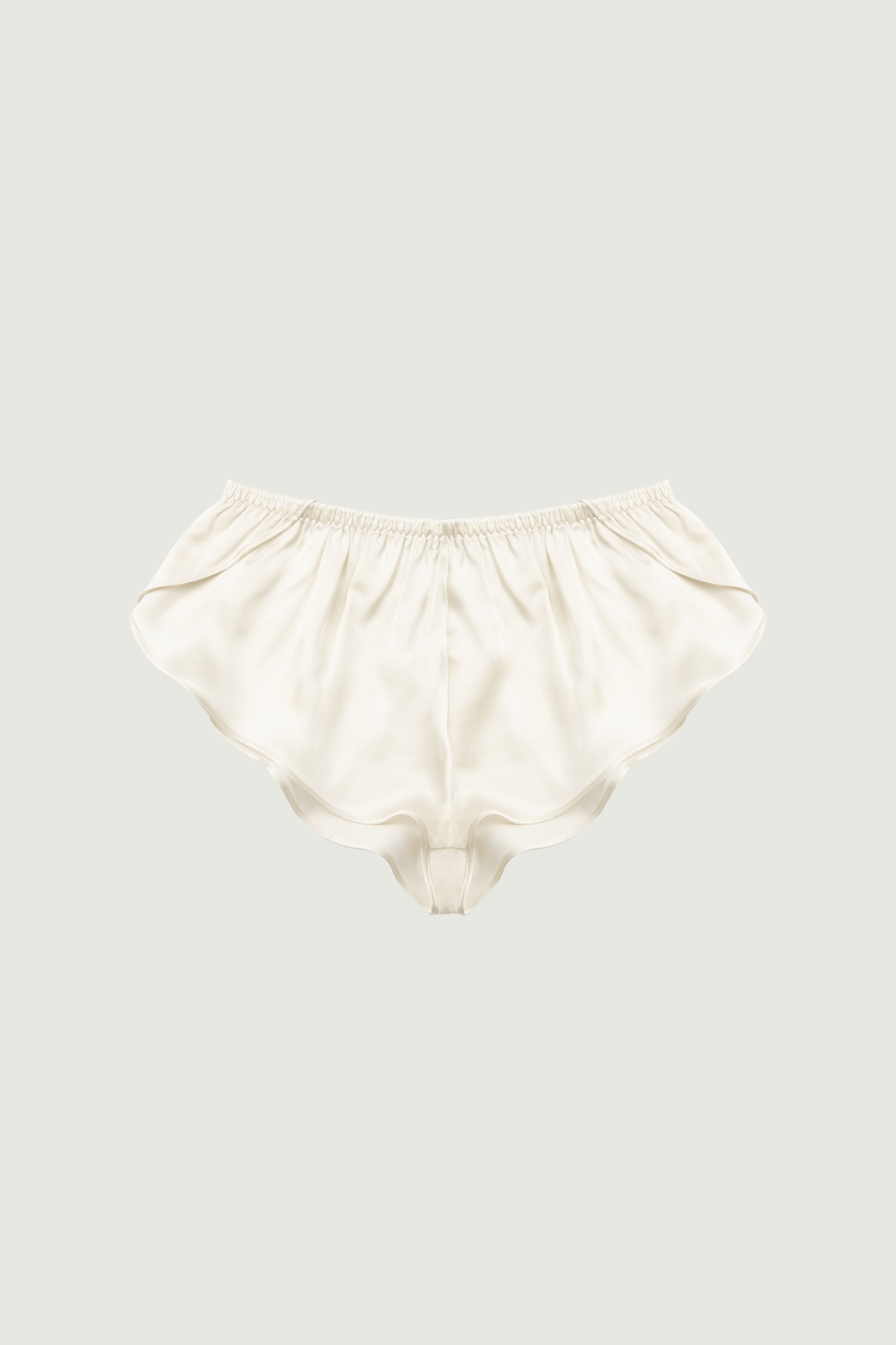 Almond silk culotte shorts, front view showing soft drape and wavy hem