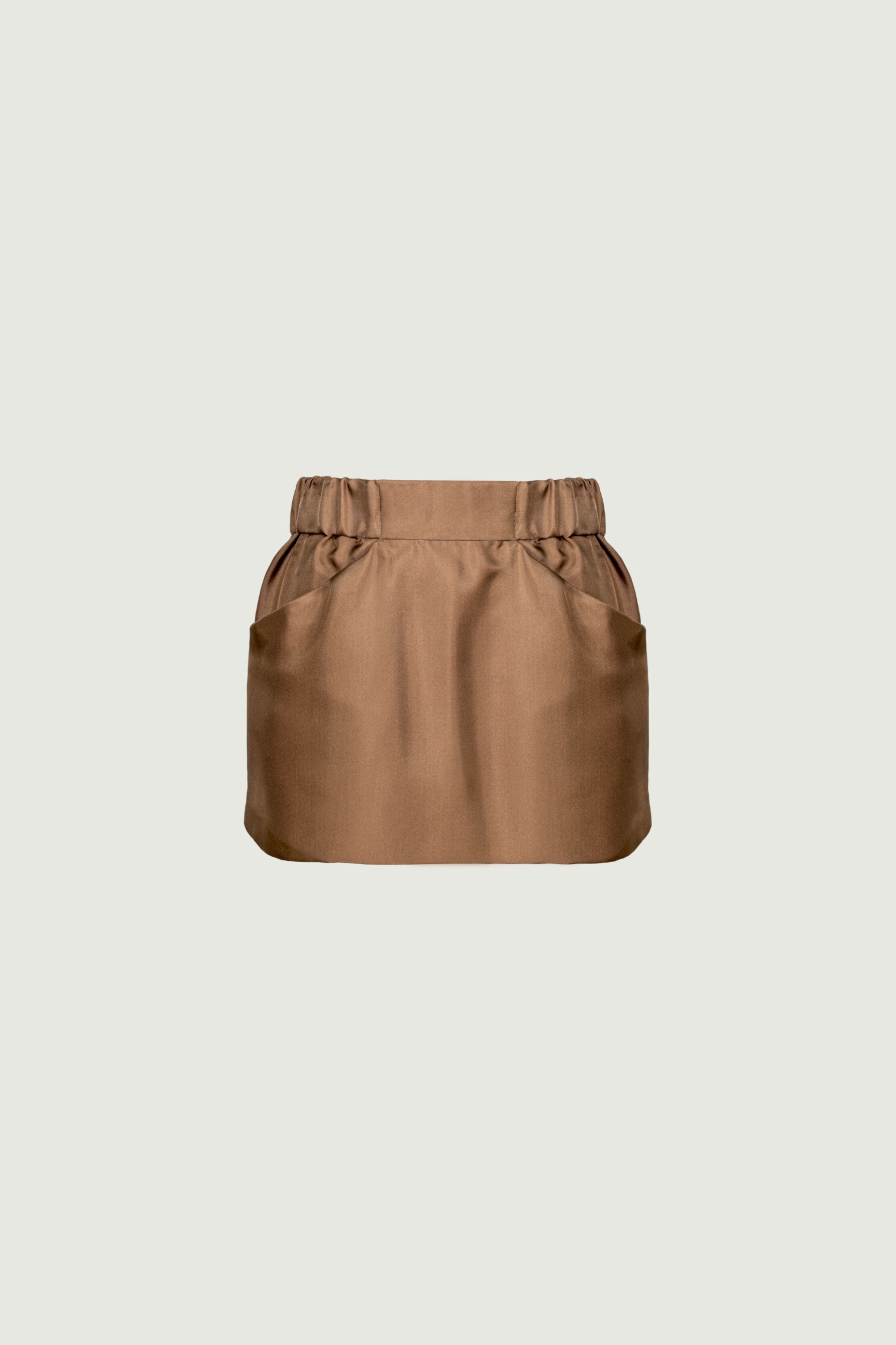Camel organic silk twill mini skirt with front pockets and structured waistband, clean shape and smooth finish, front view