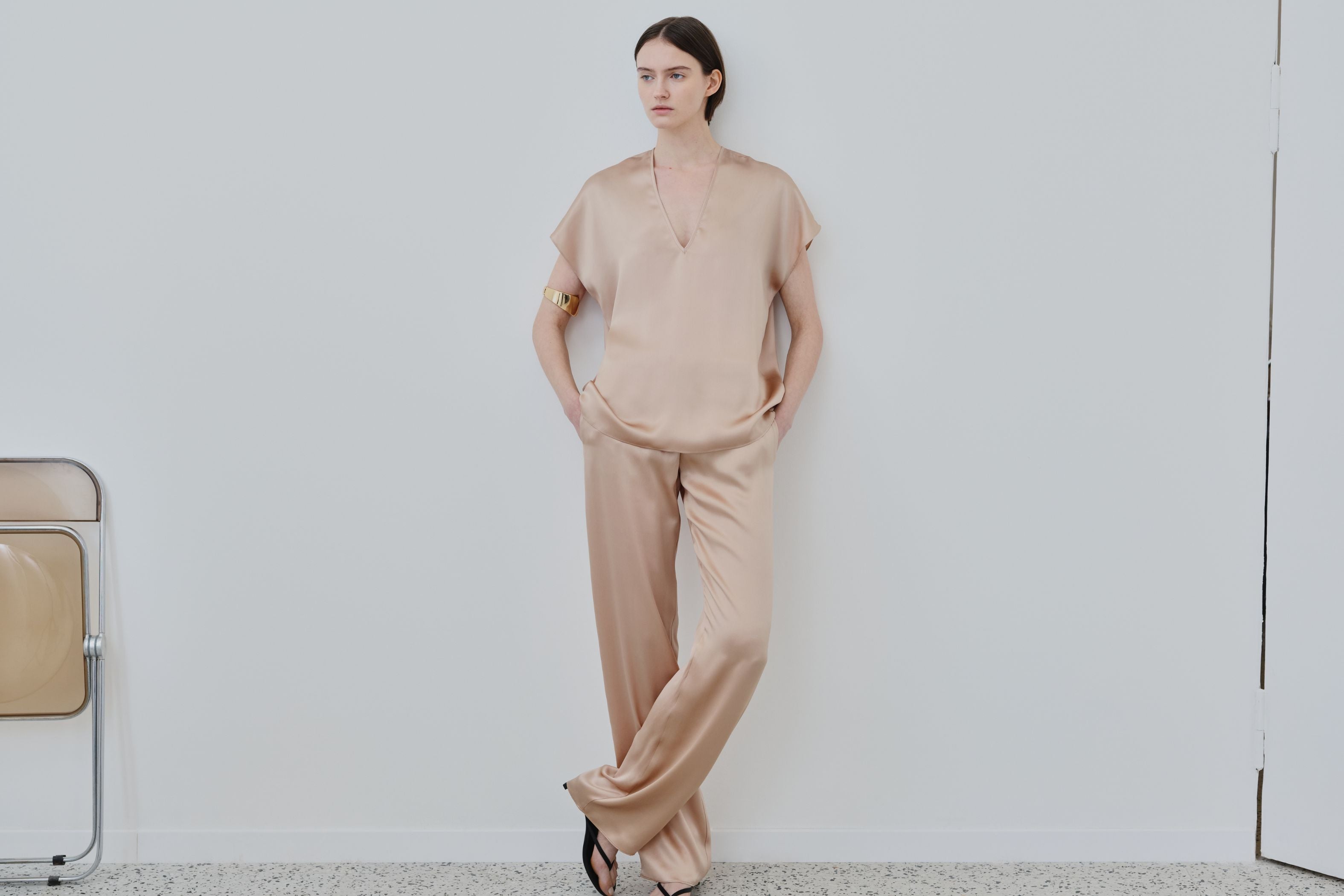 Model wearing organic silk womenswear set in sand, crafted in Italy by HERTH