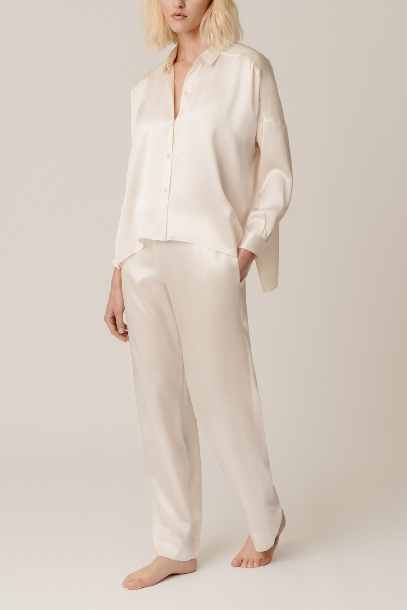 Model wearing HERTH’s Tara shirt and Zeno trousers in almond silk – front view outfit. Luxury sustainable womenswear by HERTH.