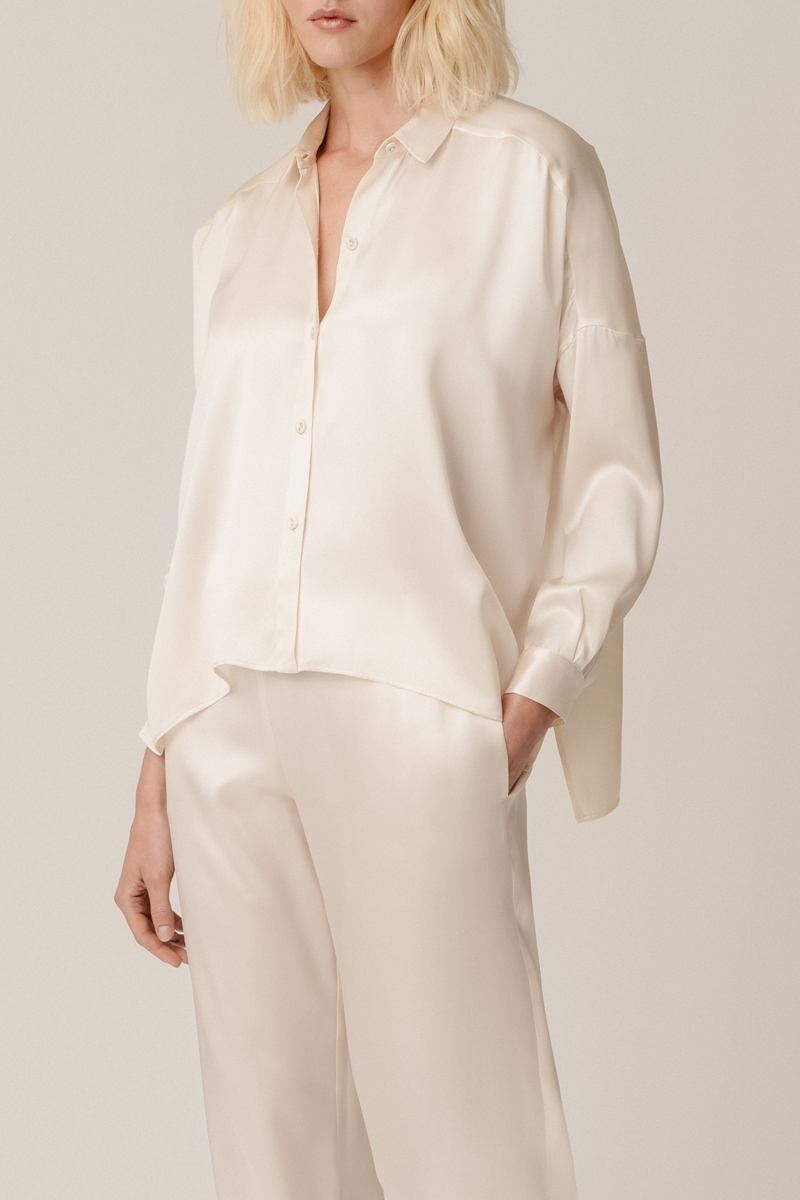 Model wearing Tara shirt and Zeno trousers almond organic silk womenswear set, front view by HERTH