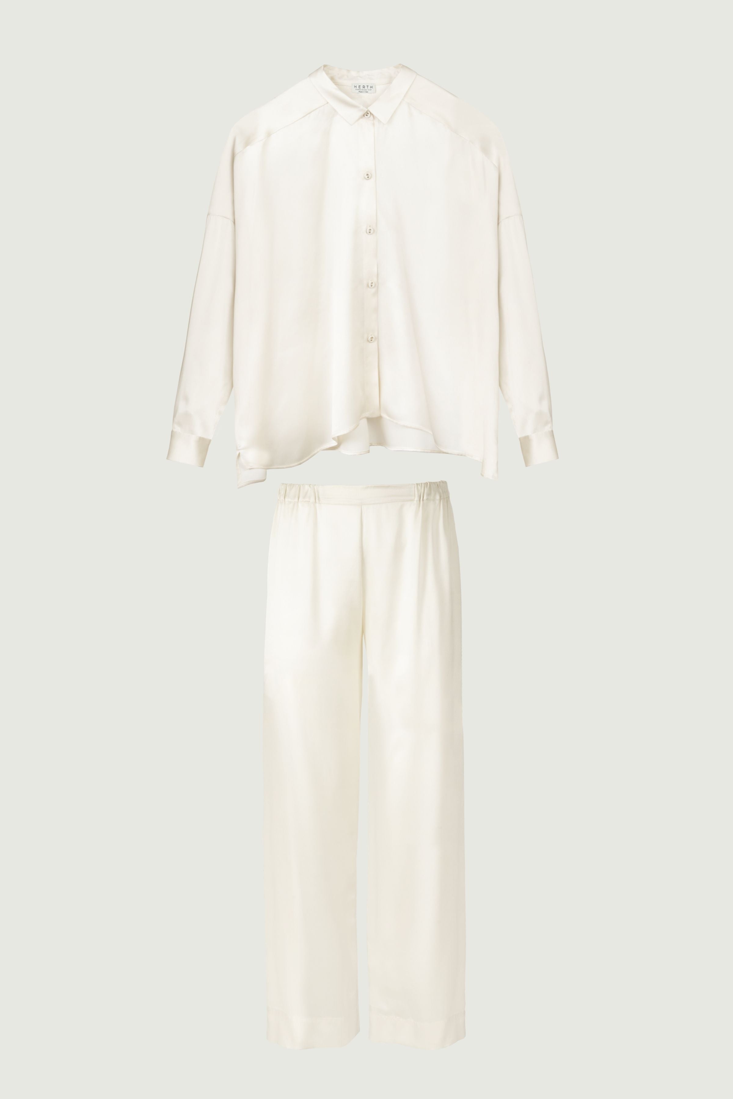 Almond silk womenswear set with relaxed shirt and wide-leg trousers, front view highlighting soft tonal palette and fluid effortless silhouette