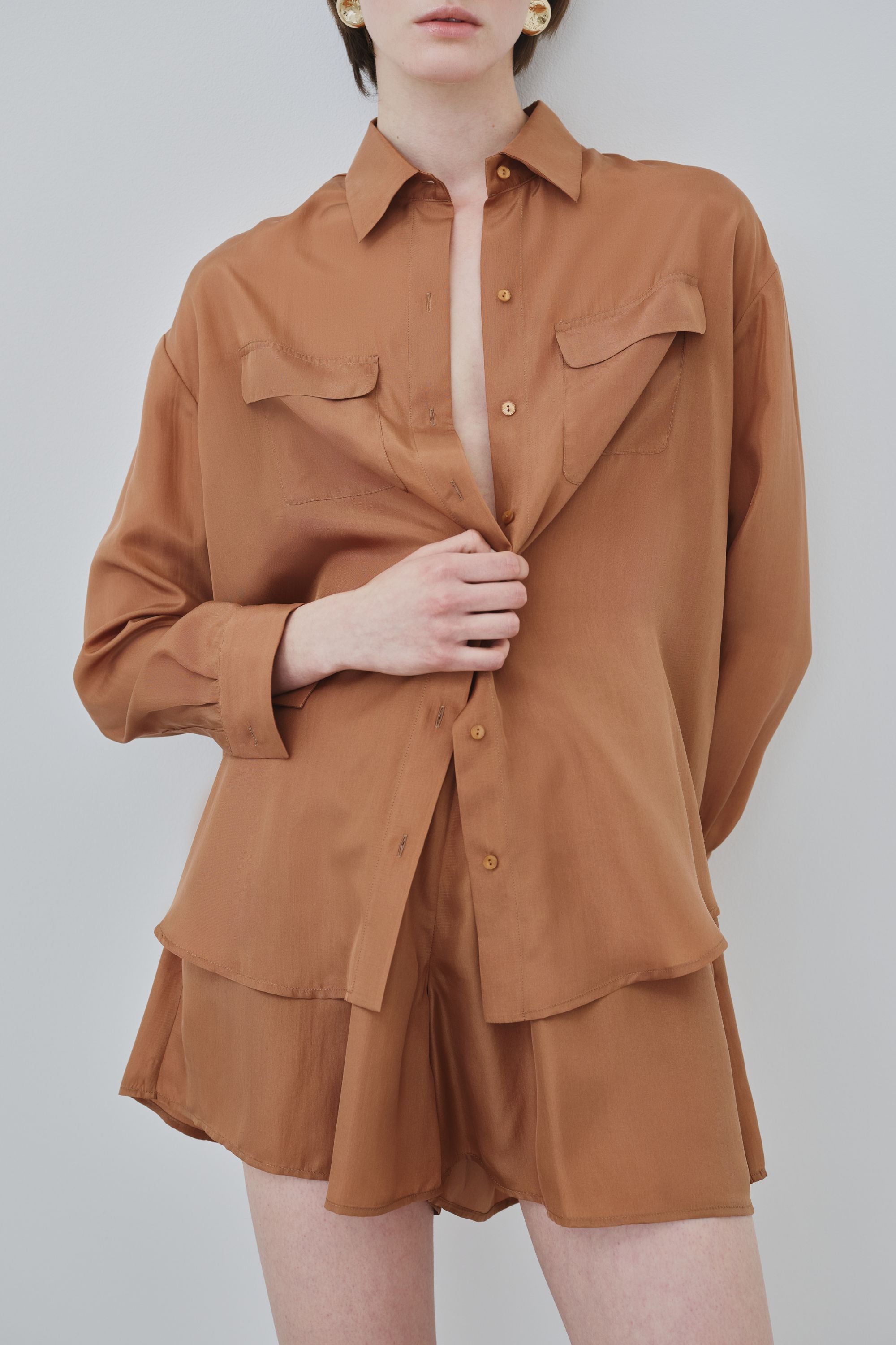 Model wearing organic silk shirt and shorts set in earth tone, Tate shirt and Hani shorts made in Italy, front view