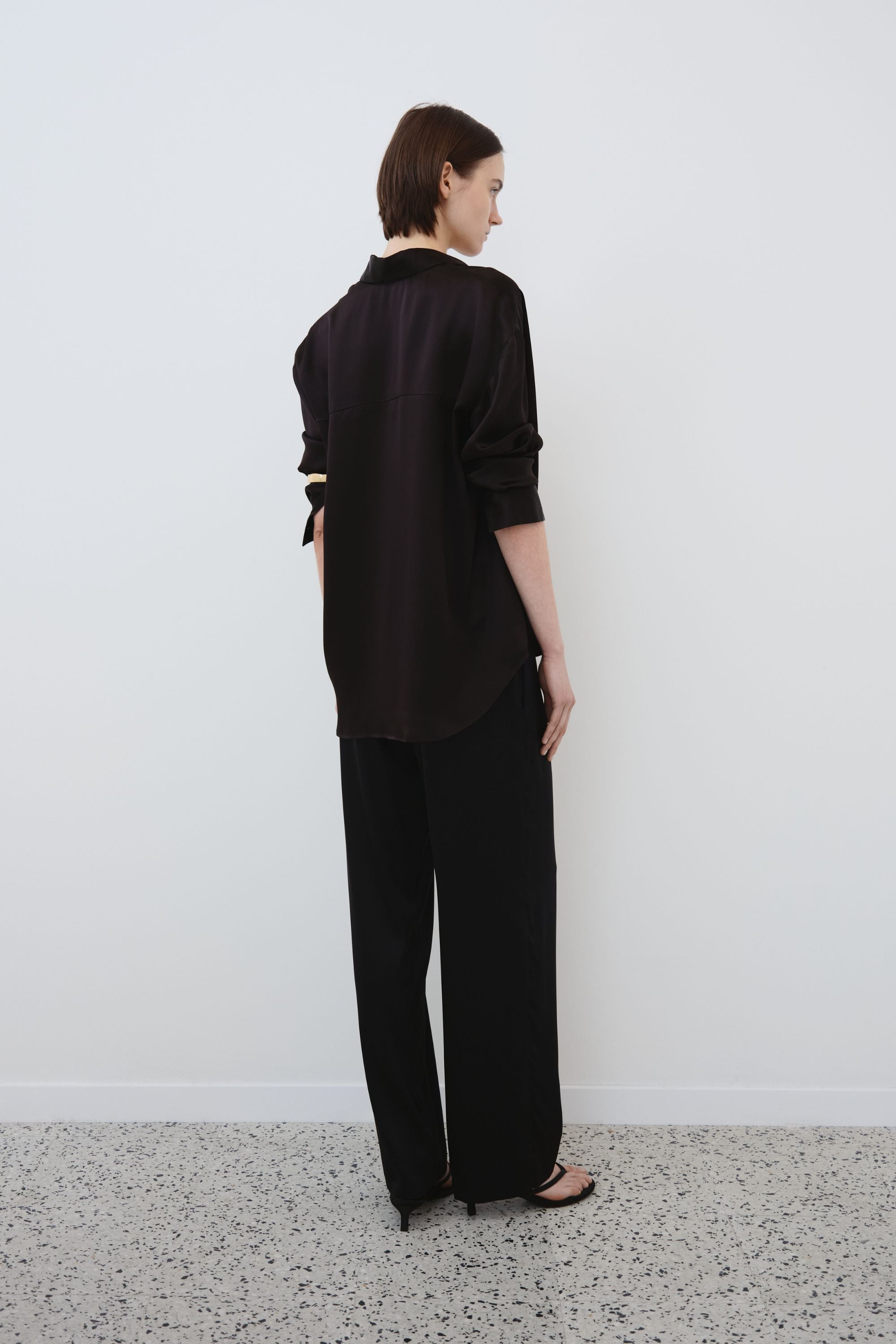 Back view of black organic silk shirt and trousers set, Tilde shirt and Zeno trousers made in Italy