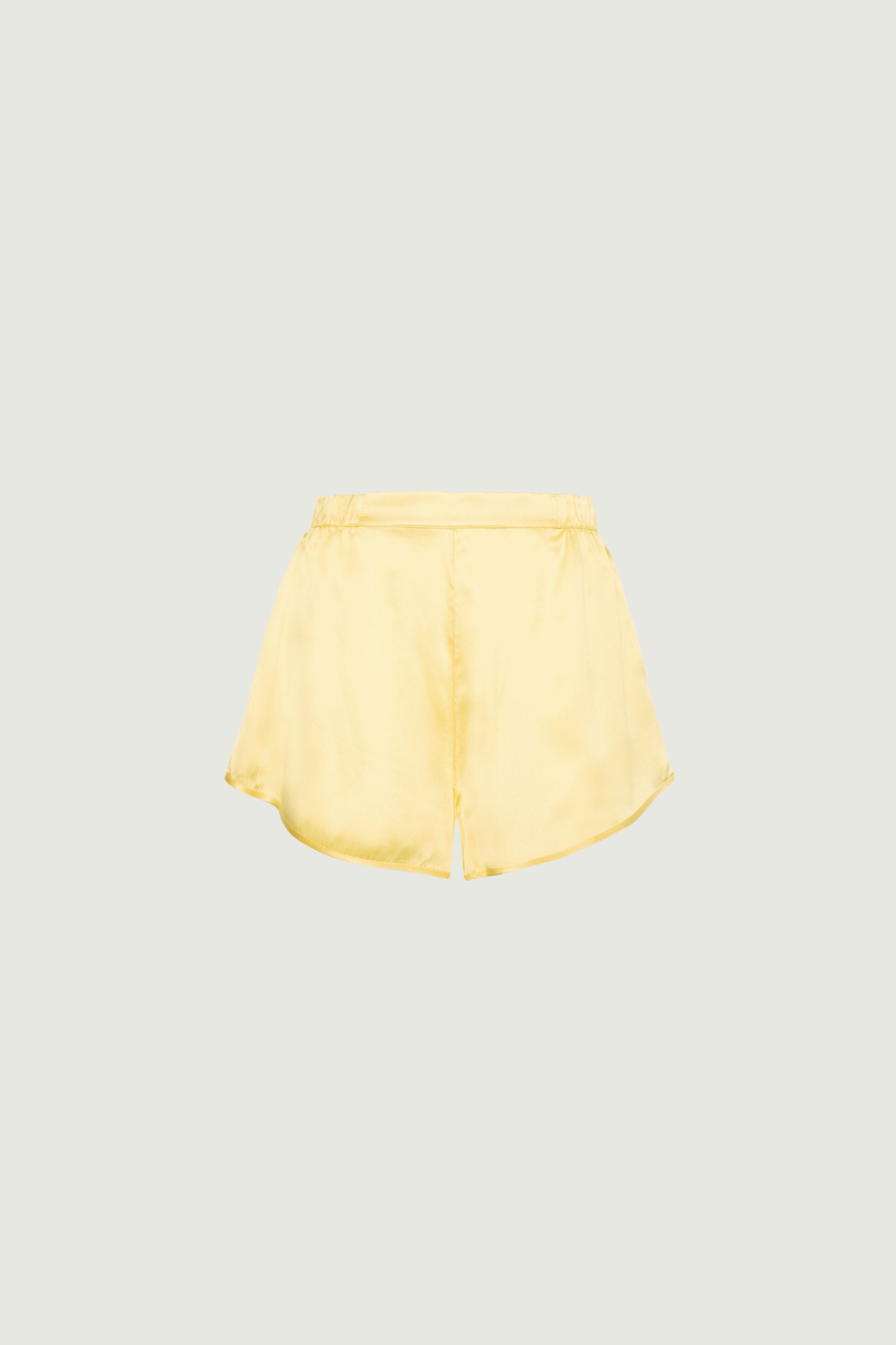 Butter yellow organic silk shorts featuring an elastic waistband and relaxed cut, lightweight feel and smooth drape, front view