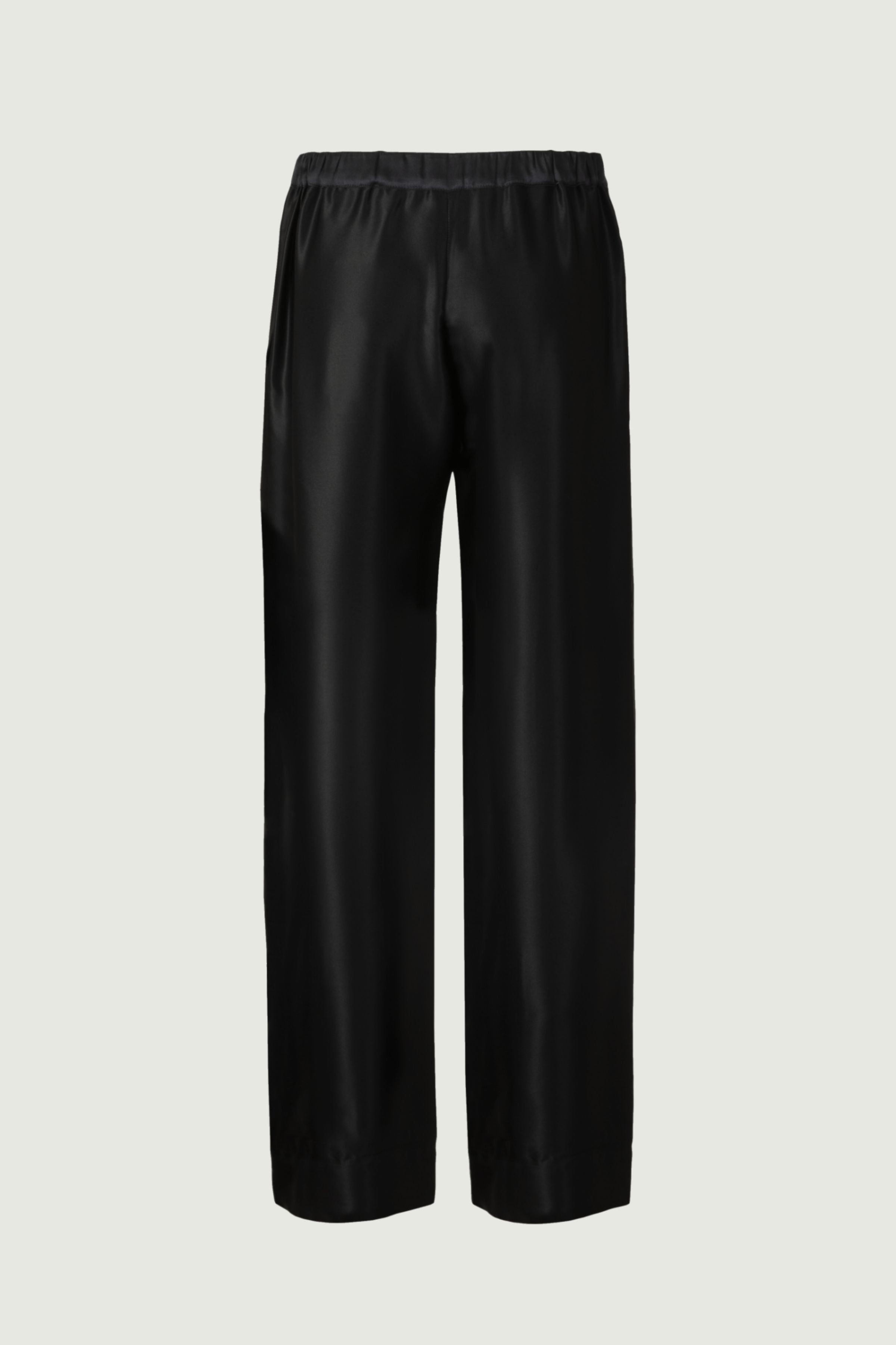 Black organic silk wide-leg trousers with elastic waistband and fluid drape, relaxed minimalist design, back view, made in Italy