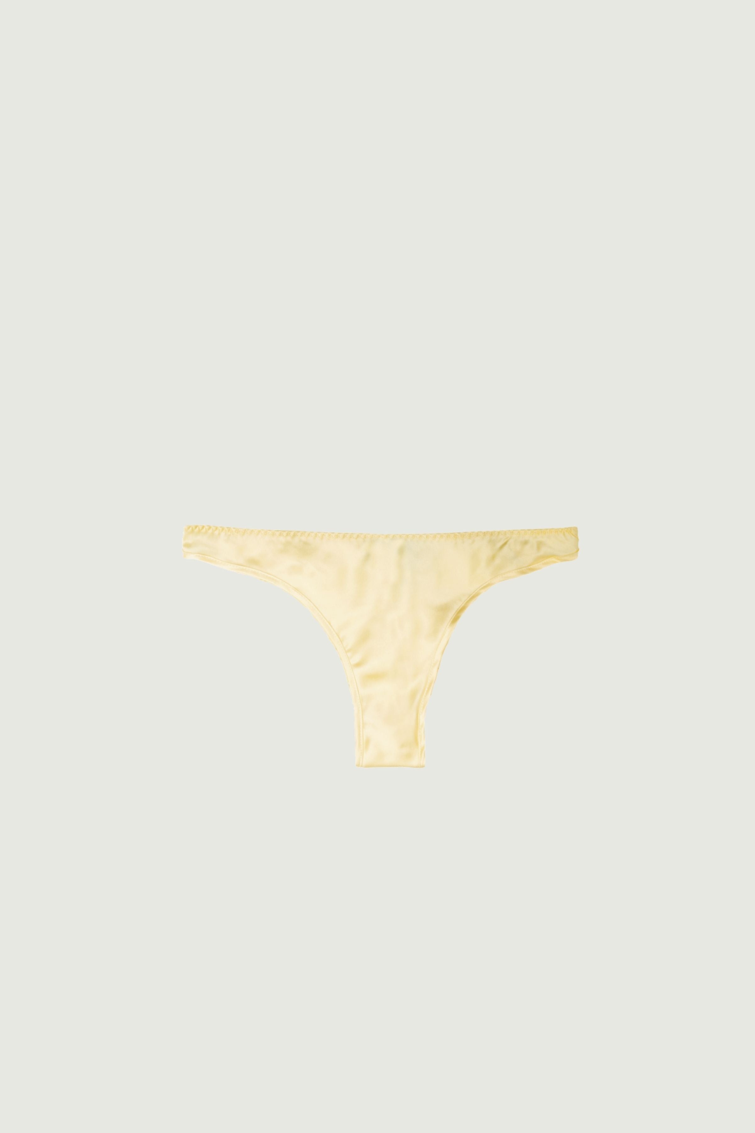 Butter yellow silk low-rise panty with minimal coverage, front view highlighting low-rise fit and soft pastel tone