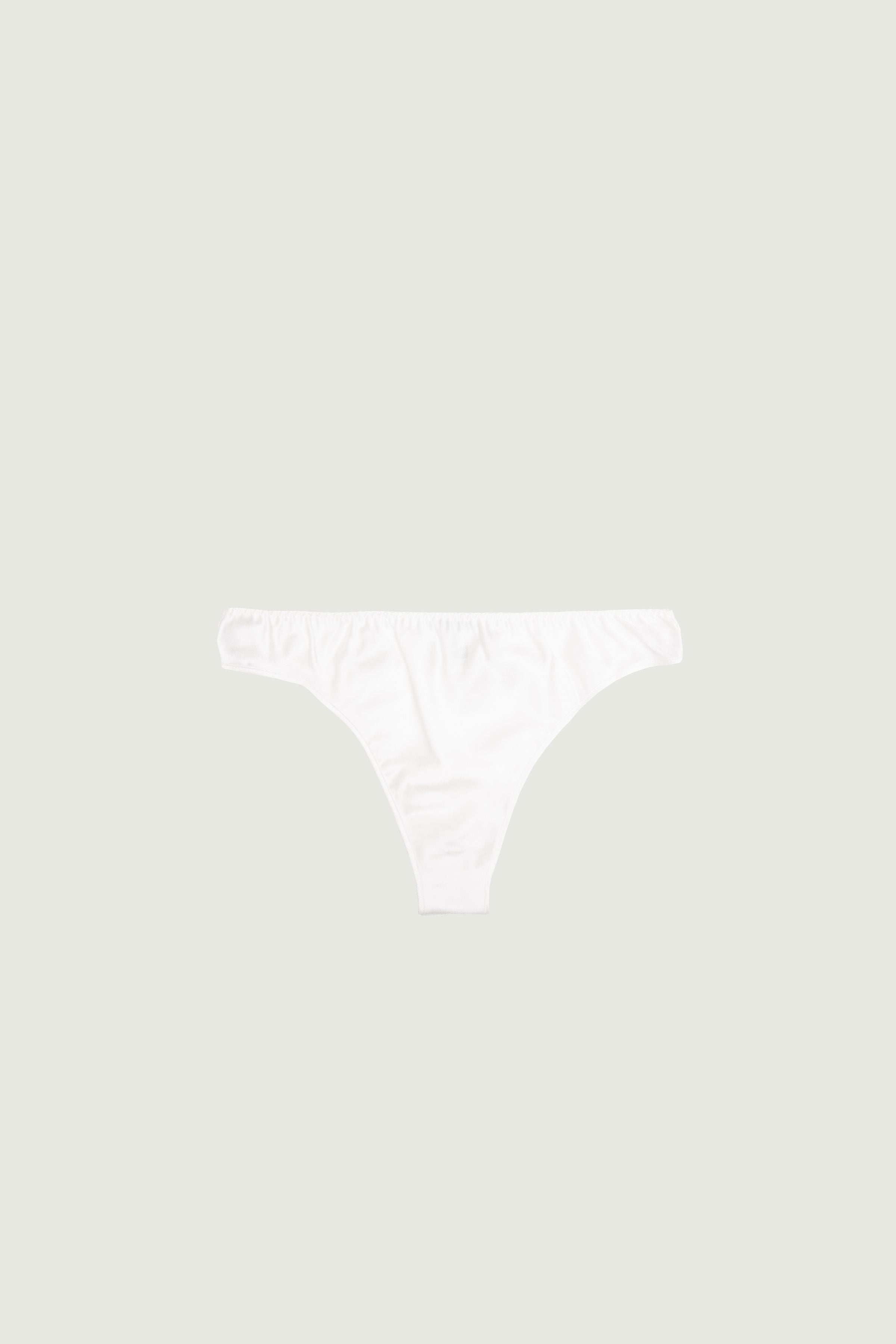 Ivory silk low-rise panty with minimal coverage, front view highlighting low-rise fit and clean light tone