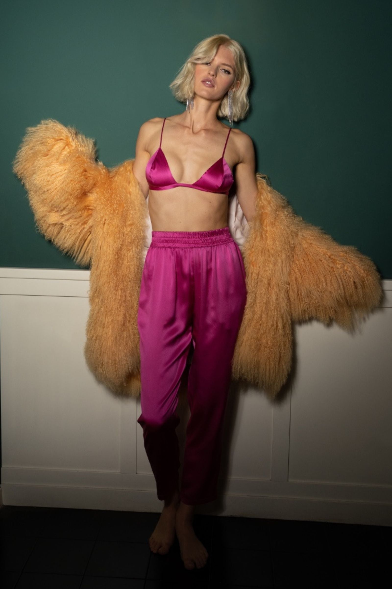 Hot pink organic silk trousers and top styled in a relaxed setting with fluid drape and soft silhouette