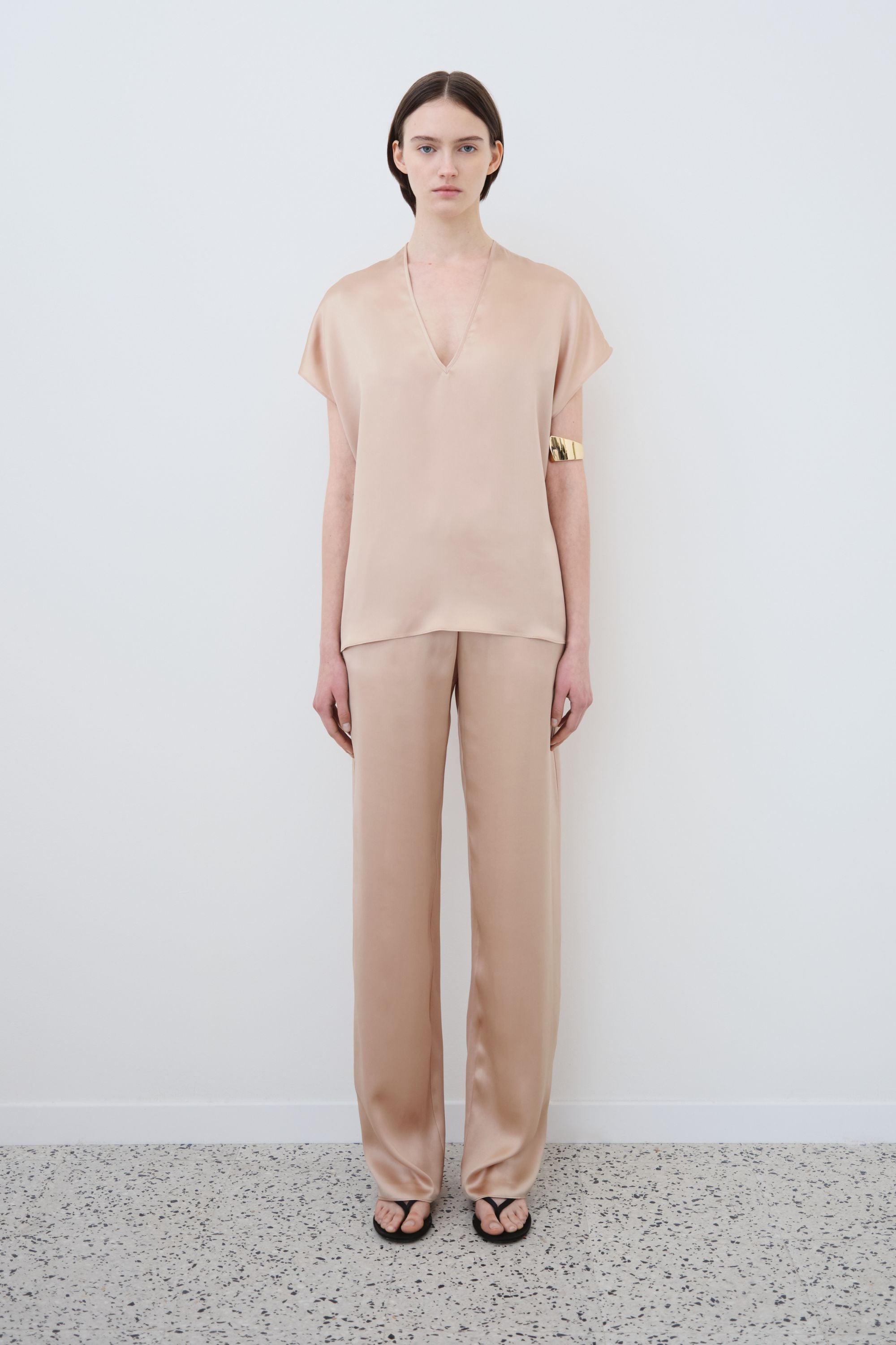 Model wearing organic silk top and trousers set in sand, Cleo top and James trousers made in Italy, front view
