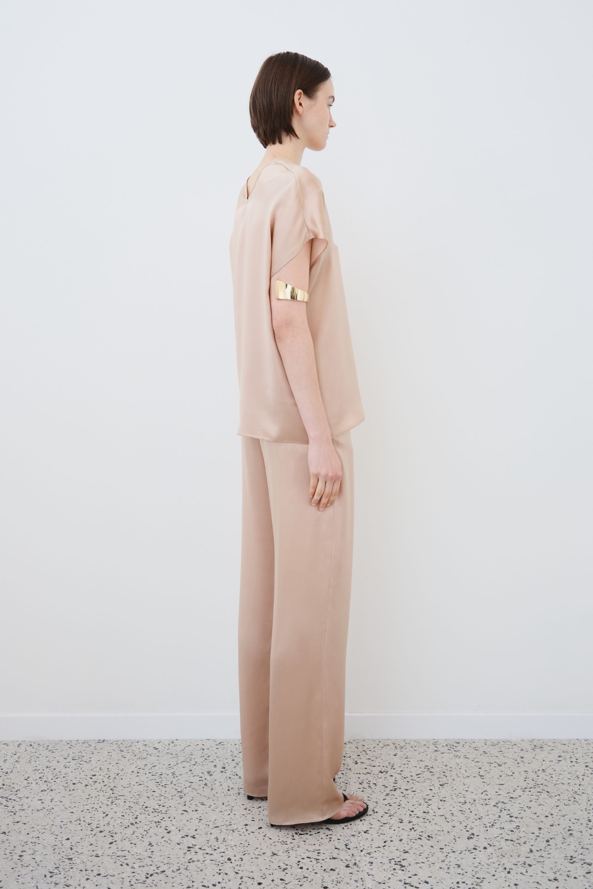 Side view of organic silk top and trousers set in sand, Cleo top and James trousers made in Italy