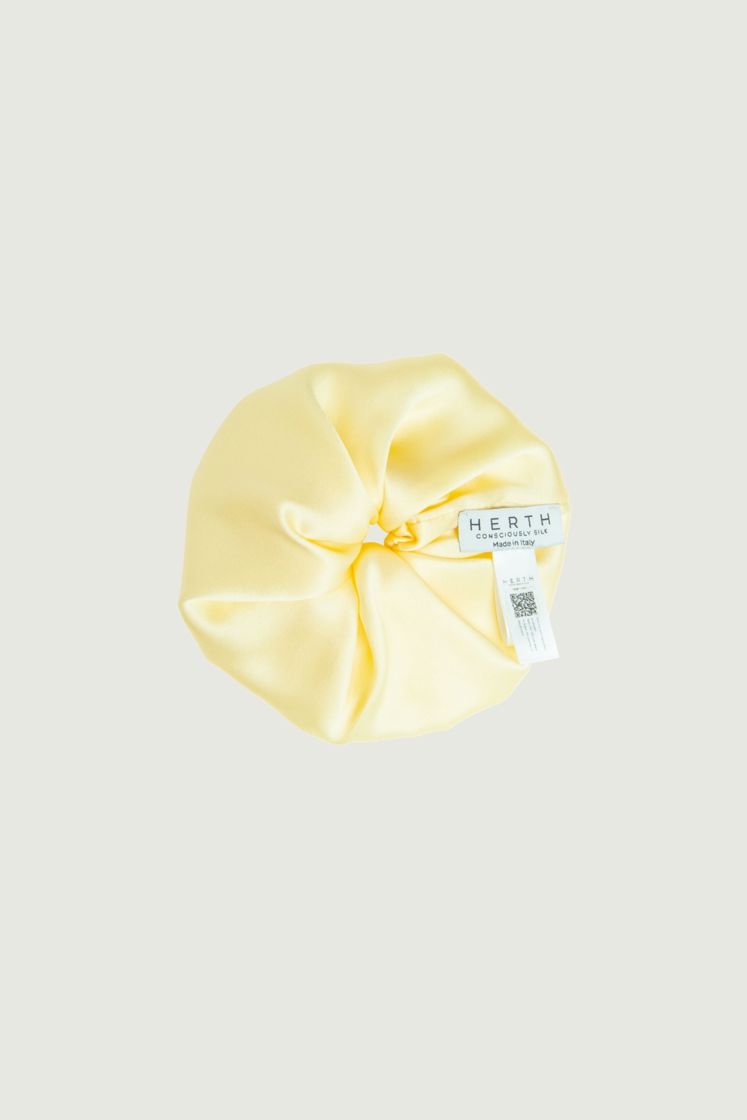 Butter yellow silk scrunchie, close-up showing smooth satin surface