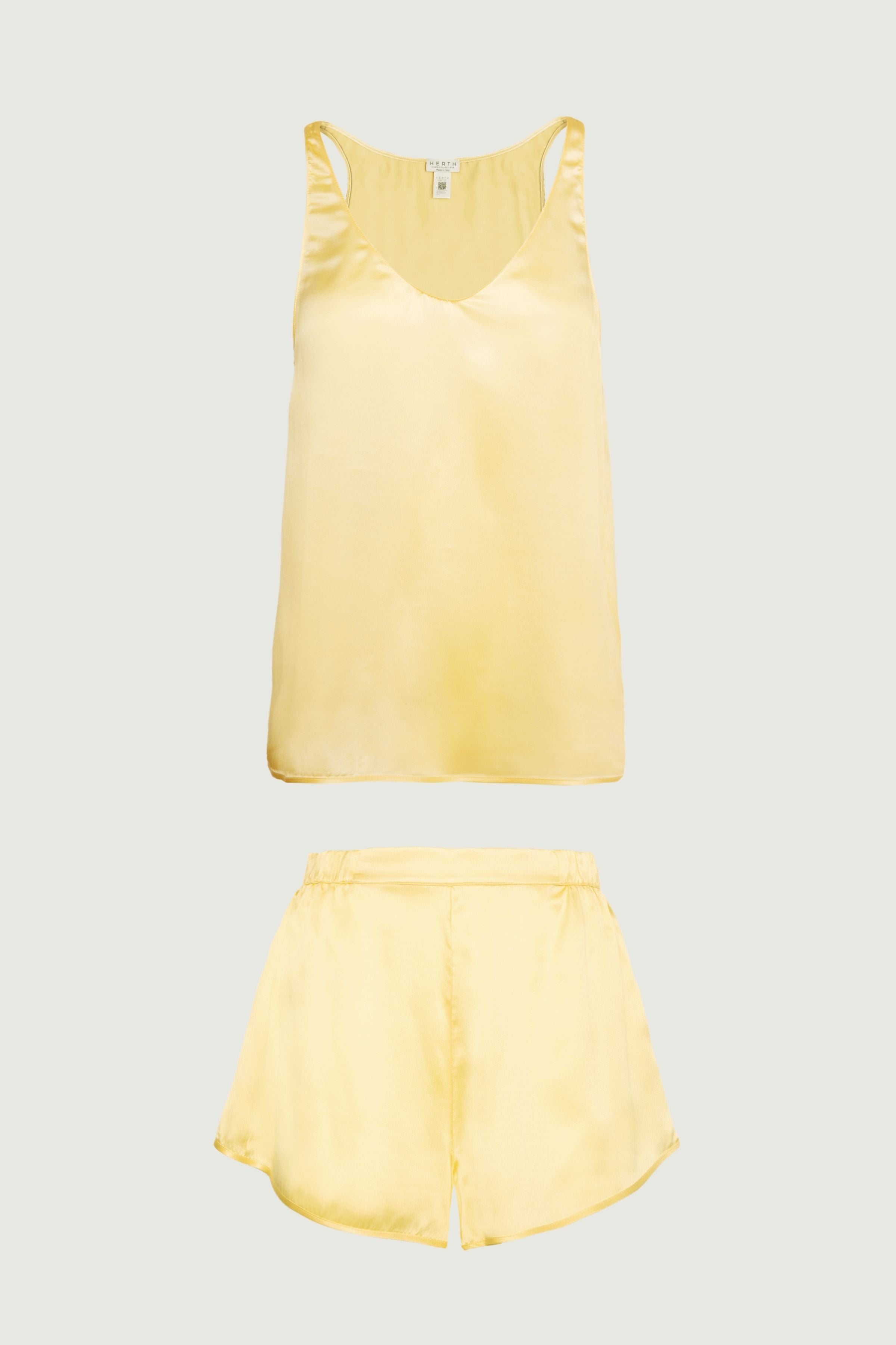 Butter yellow silk womenswear set with tank top and relaxed shorts, front view highlighting light summer tone and easy fluid silhouette
