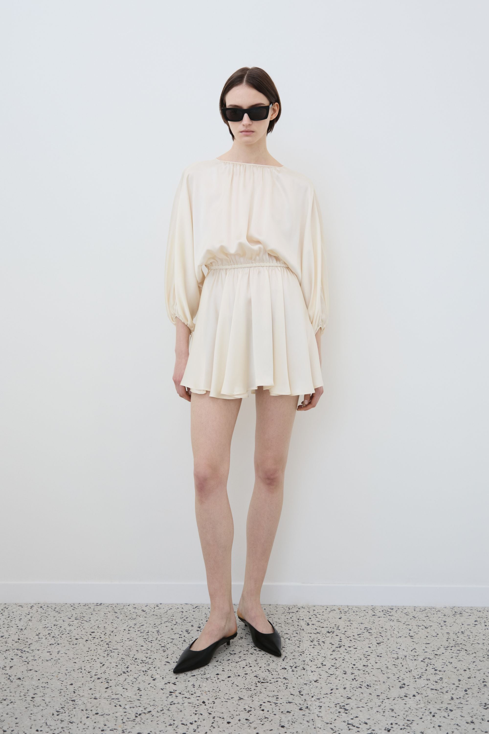 Model wearing organic silk mini dress in almond, Ema dress made in Italy, front view