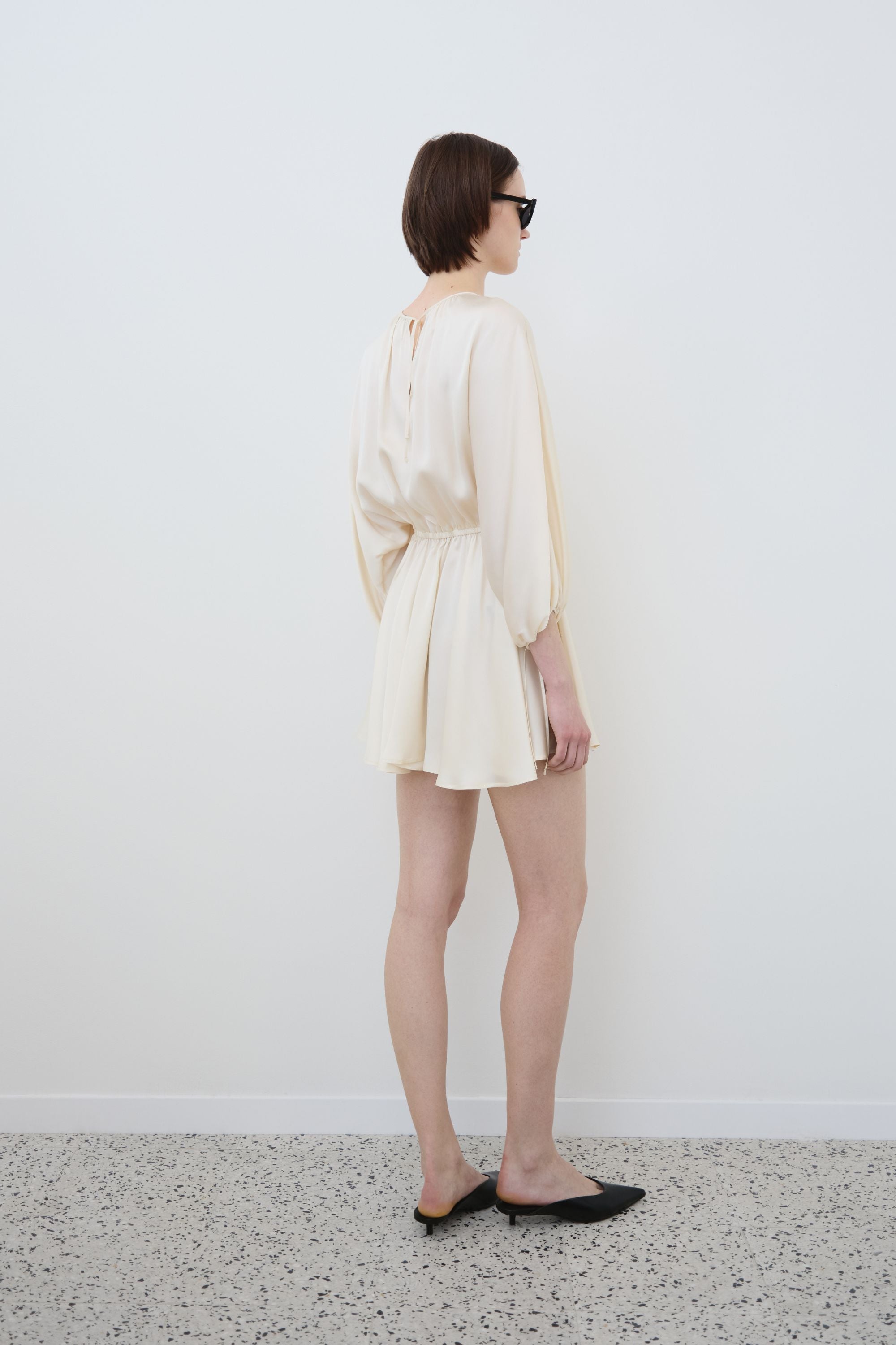 Side view of organic silk mini dress in almond, Ema dress made in Italy