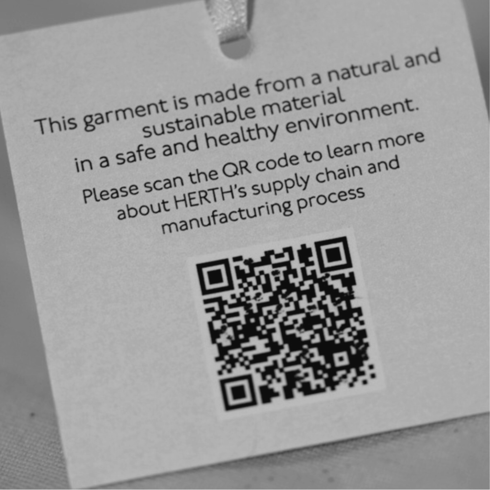 HERTH garment tag with QR code showing blockchain transparency and traceable Italian supply chain