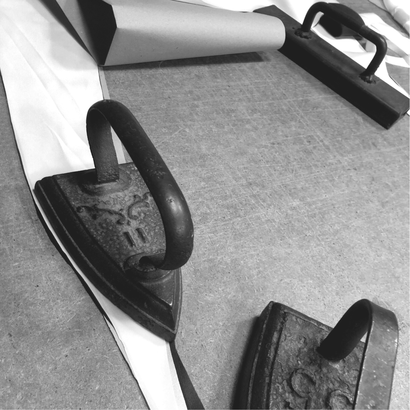 Traditional artisan pressing tools used in HERTH’s Crafted in Italy organic silk production, symbolizing meticulous craftsmanship and sustainable luxury.