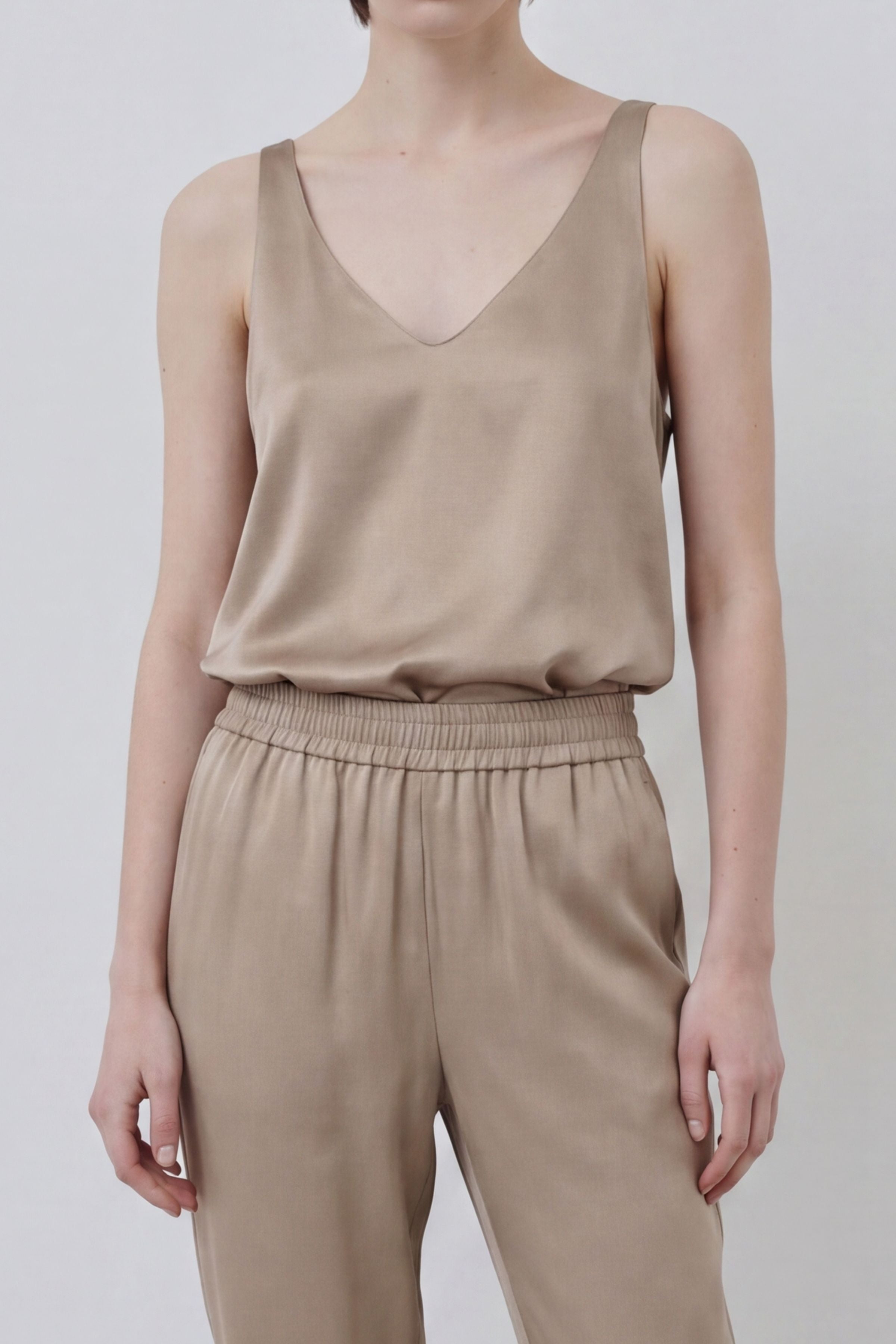 Organic silk Else tank and Roy trousers in gold sand, close-up view highlighting texture and waistband detail