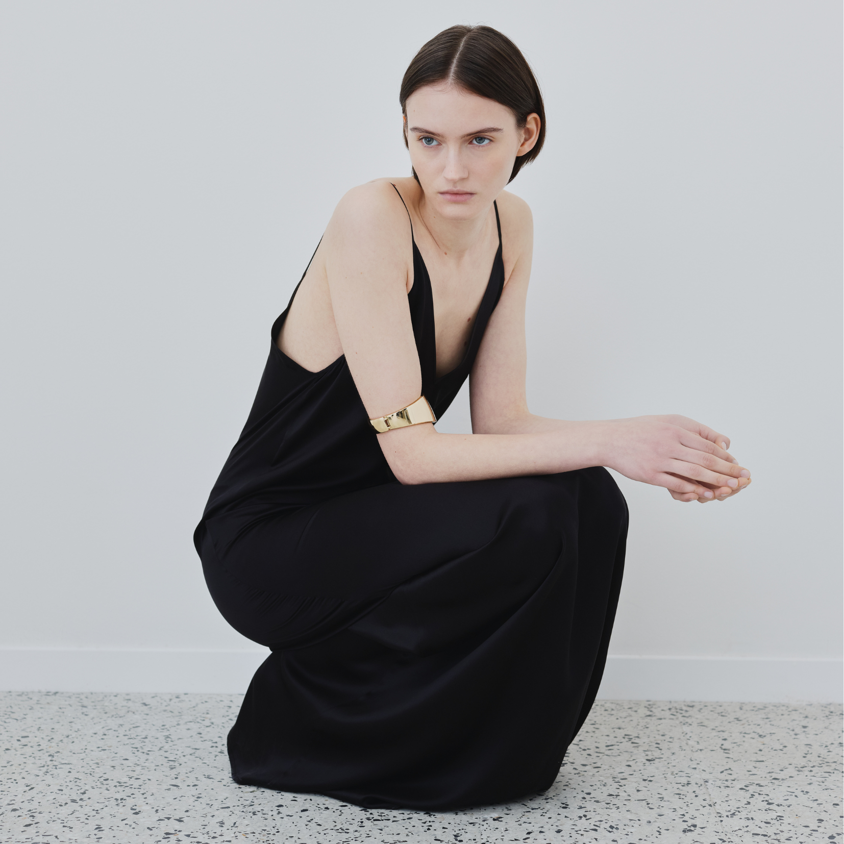 Model wearing the Inez black silk slip dress by HERTH, crafted in Italy from certified organic silk.