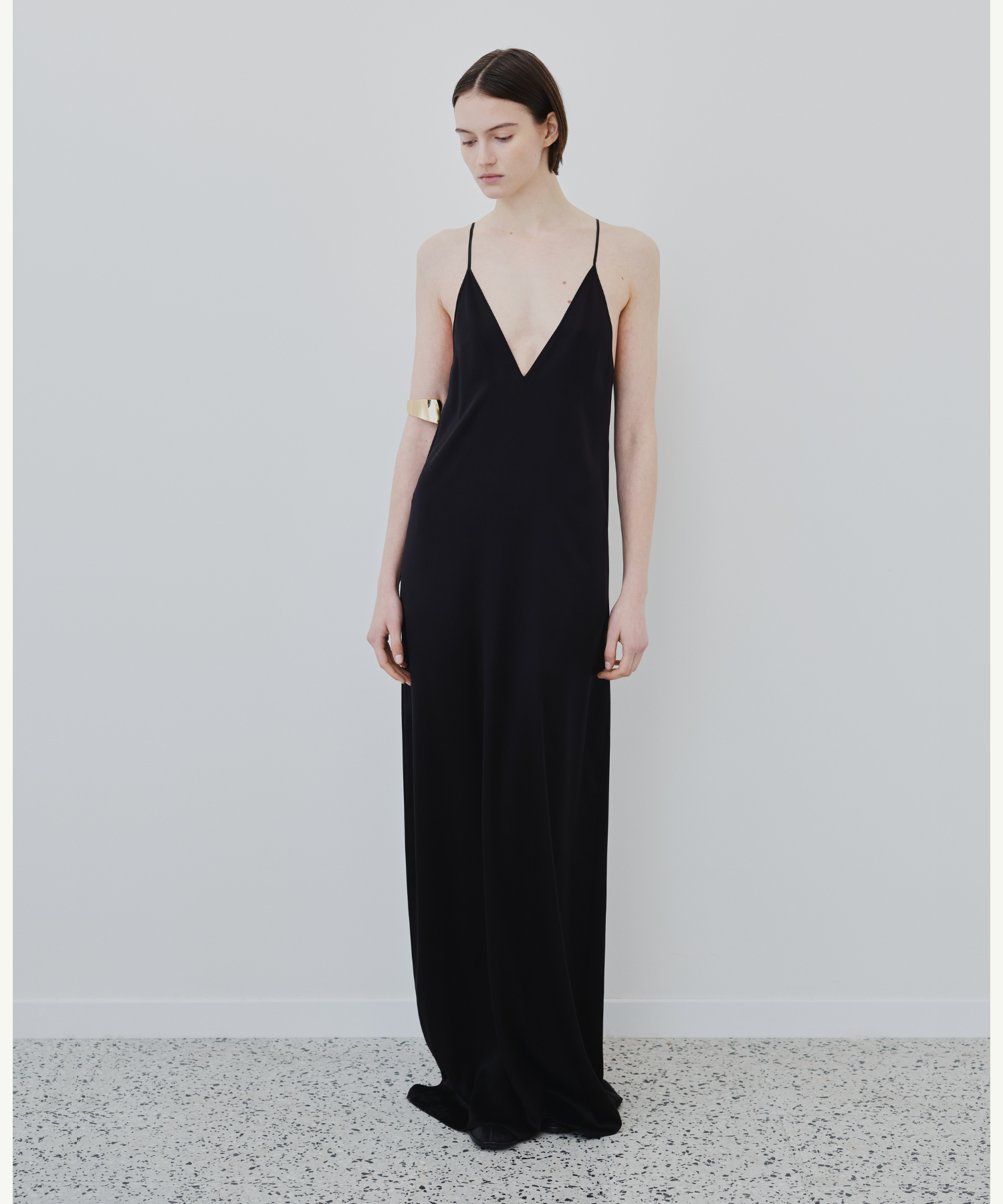 Model wearing HERTH Inez organic silk slip dress in black, sustainable luxury eveningwear and timeless lingerie-inspired style.