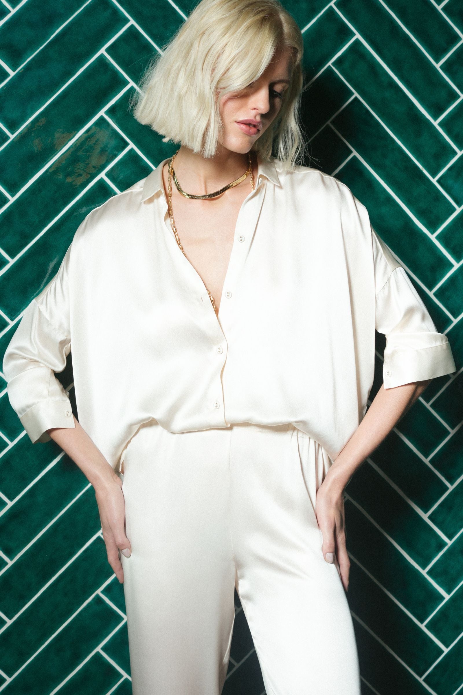 Ivory organic silk shirt worn with relaxed silhouette, fluid drape and soft sheen, crafted in Italy
