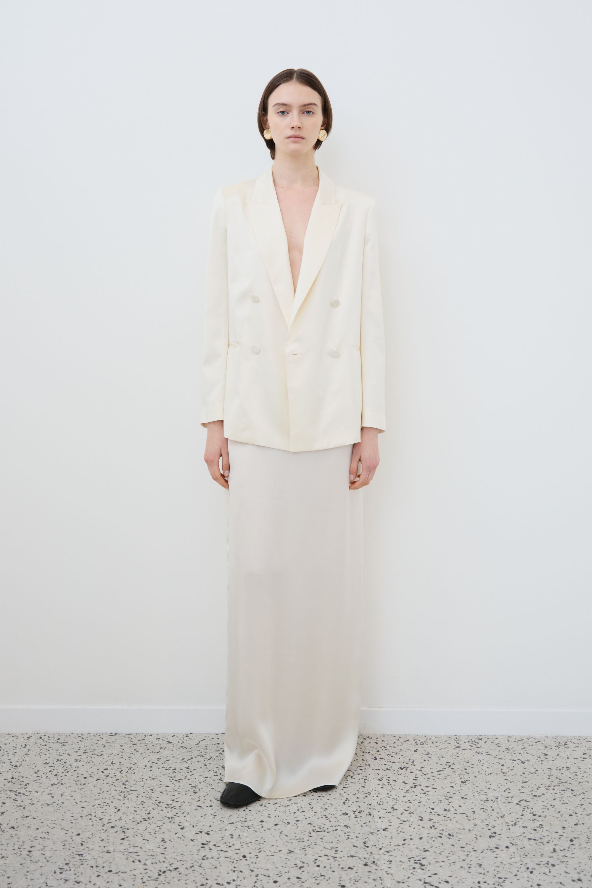 Front view of the Nilde organic silk maxi skirt in Almond styled with an almond double-breasted blazer.