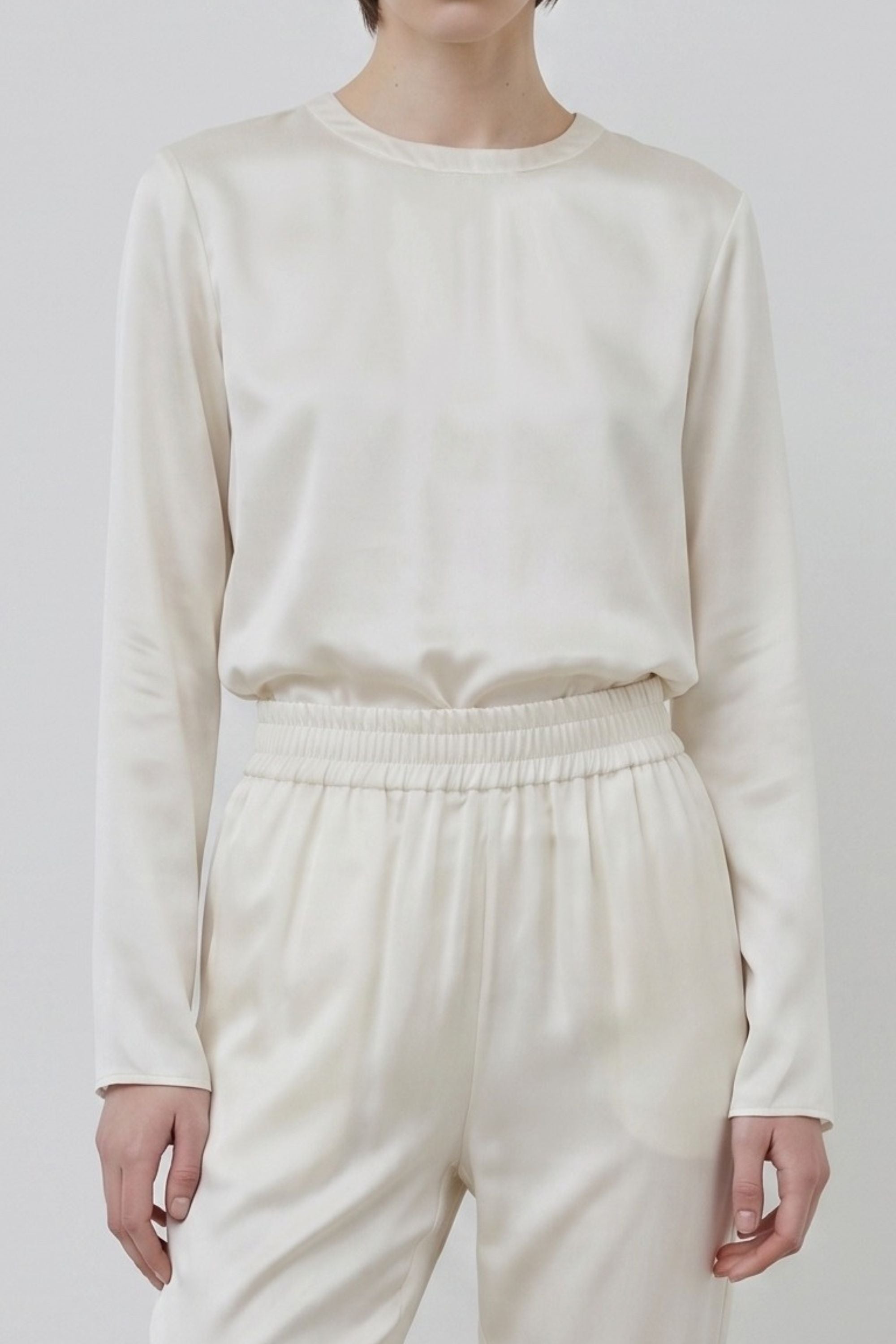 Organic silk Andie top and Roy trousers in ivory, detail of texture and fit, close-up