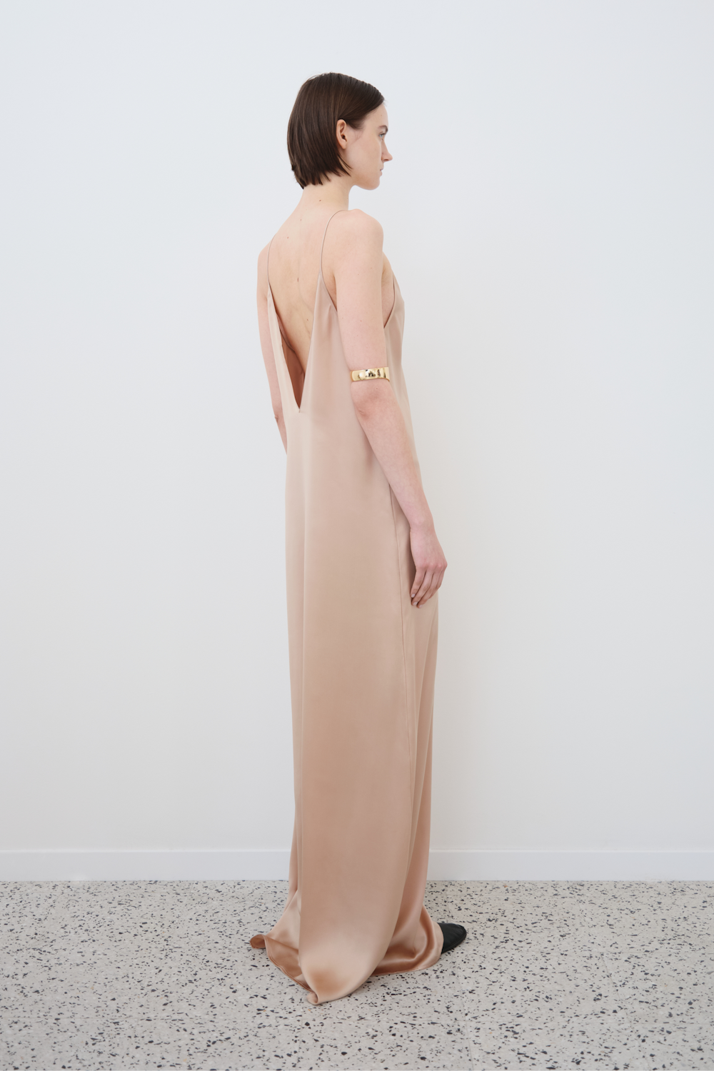 Side view of the Inez slip dress in sand — minimal silhouette crafted from GOTS-certified organic silk, luxury sustainable womenswear by HERTH.