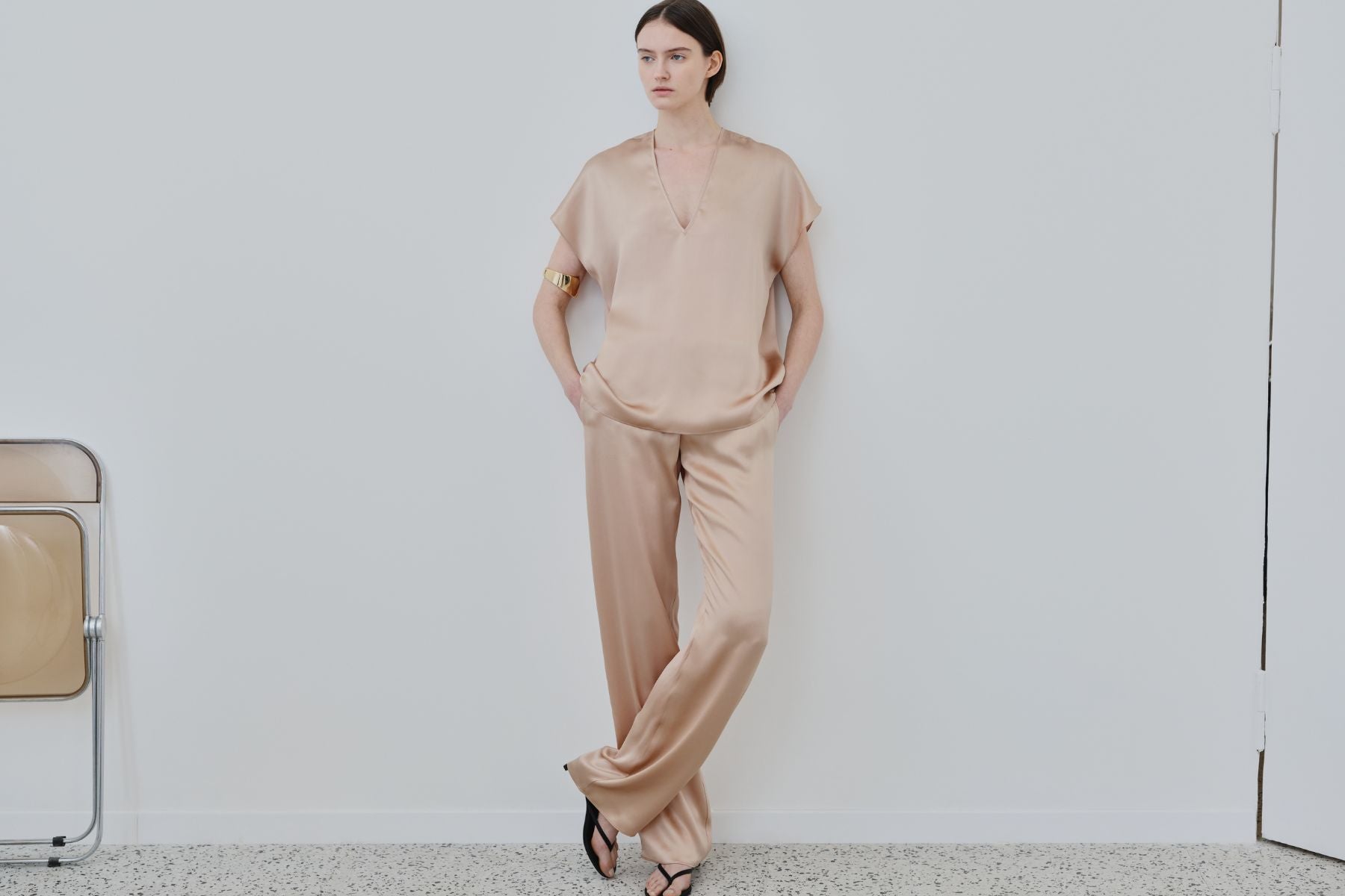 Model wearing organic silk womenswear set in sand, crafted in Italy by HERTH