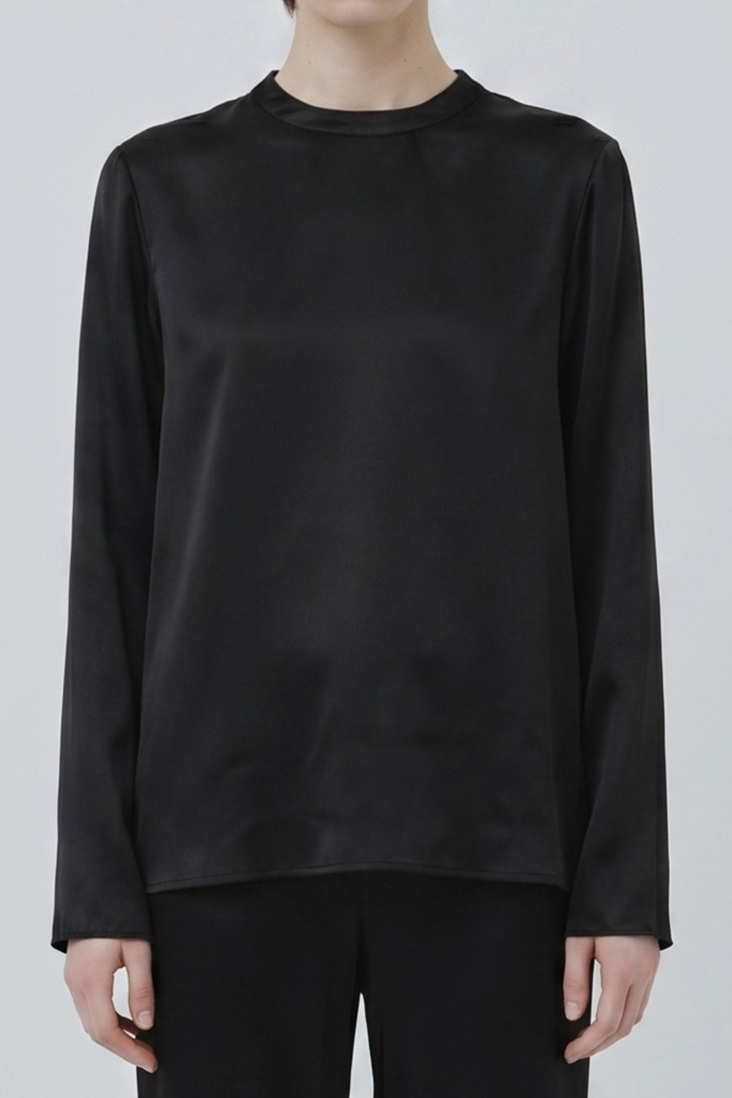 Organic silk long sleeve top in black close-up, smooth texture and clean silhouette, made in Italy