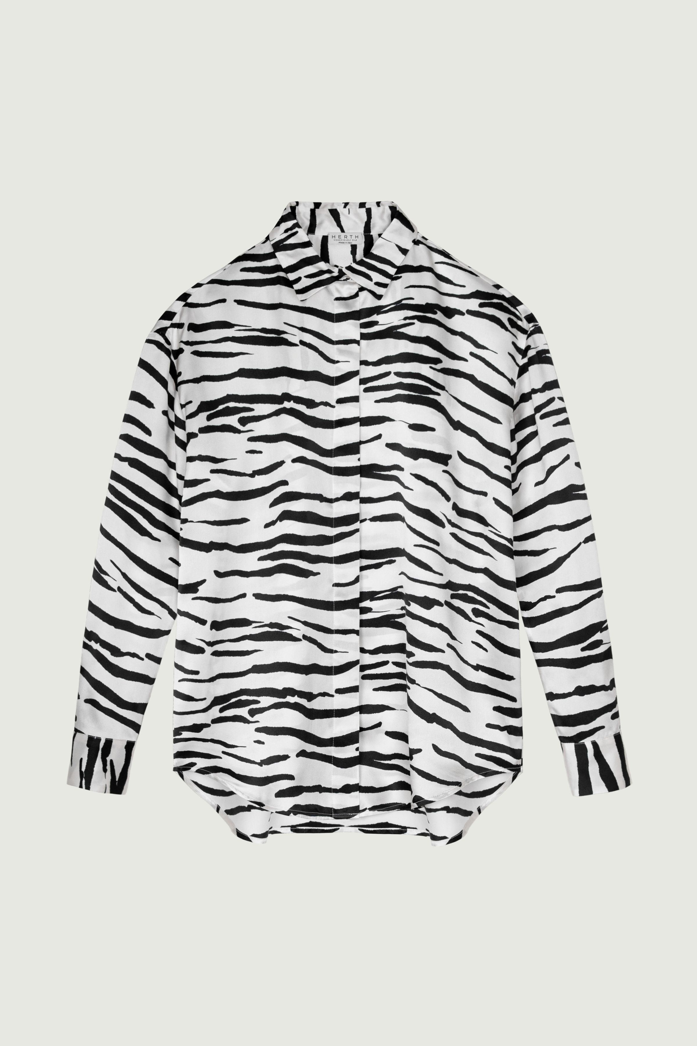 Zebra print silk shirt with relaxed fit, long sleeves and fluid drape, button-down front, lightweight structured silhouette