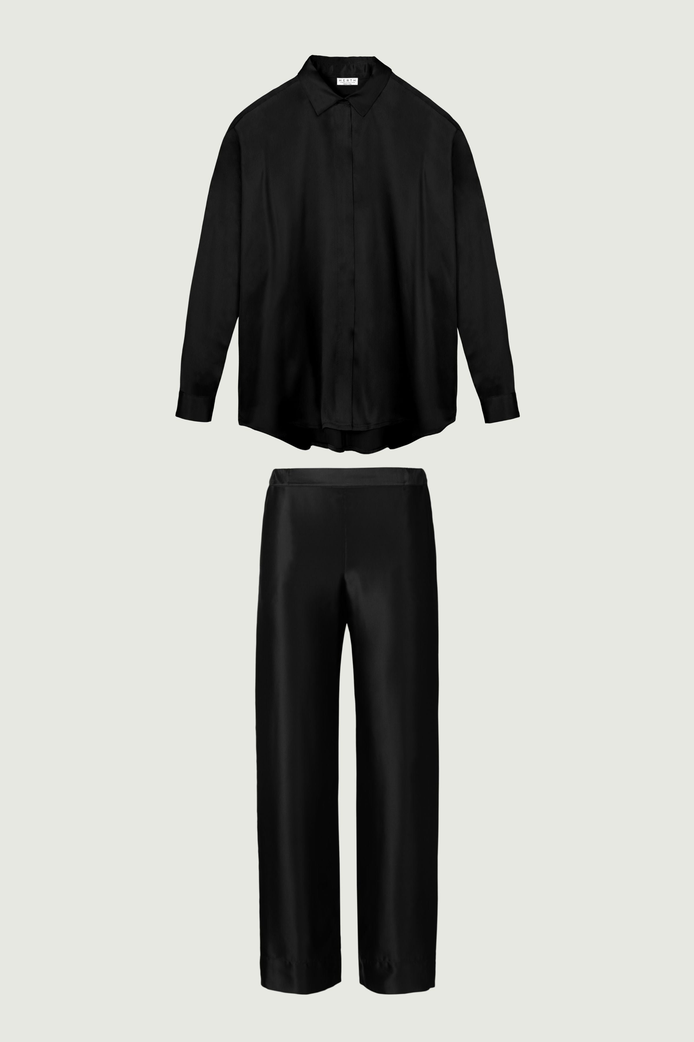 Black silk womenswear set with relaxed shirt and wide-leg trousers, front view highlighting fluid tailoring and clean coordinated silhouette