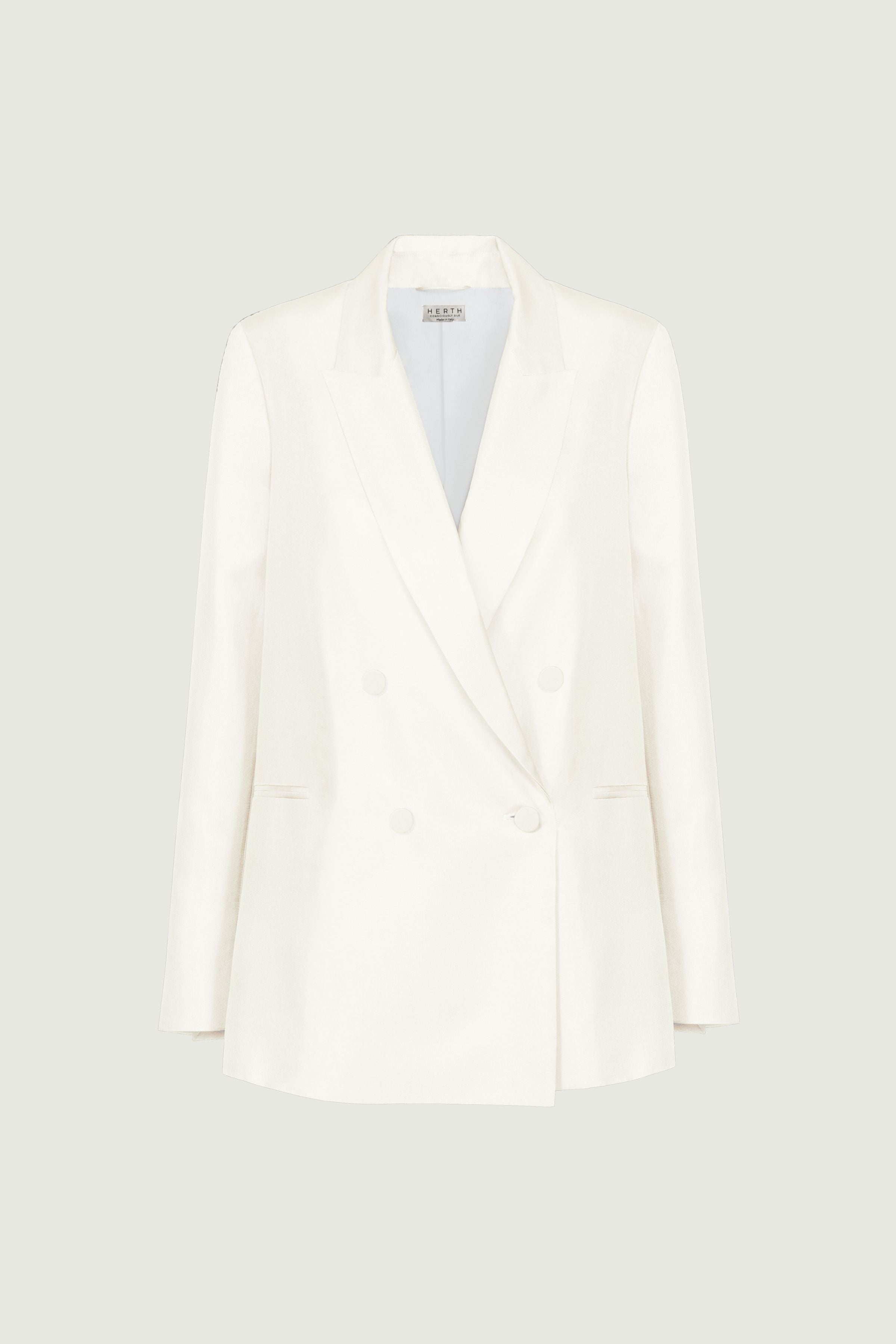 Almond double-breasted blazer with tailored silhouette, structured shoulders and sharp lapels, clean minimal construction, front view