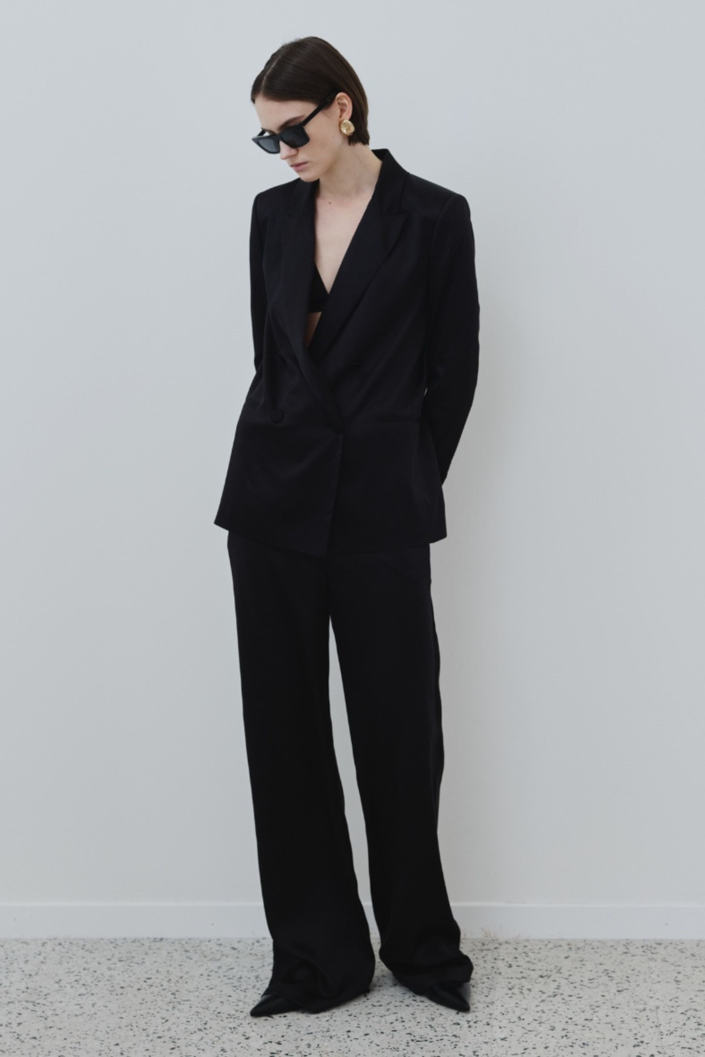 black silk blazer with matching trousers styled over a silk triangle bra, elegant minimal outfit made in Italy