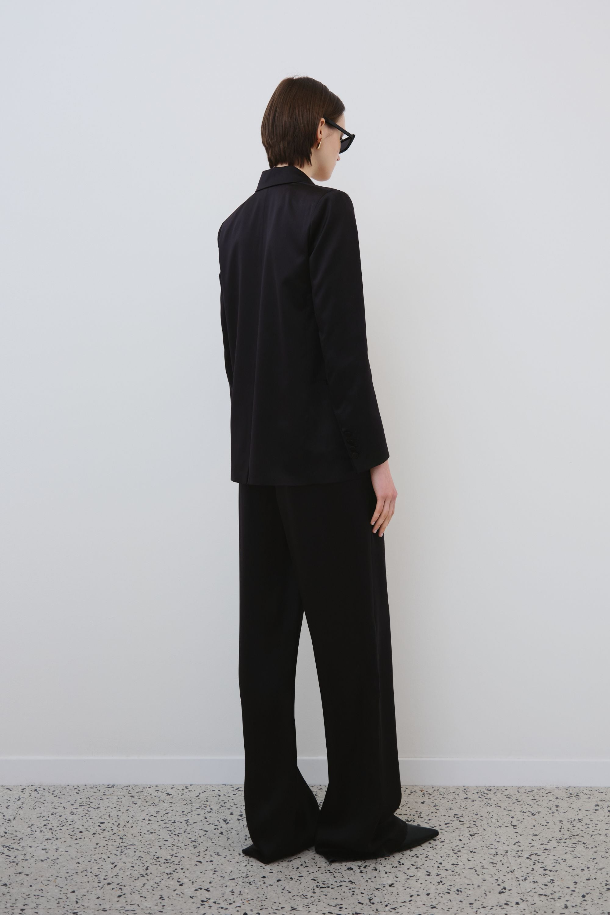 Back view of black organic silk blazer and trousers set, Uma blazer and Joy trousers made in Italy