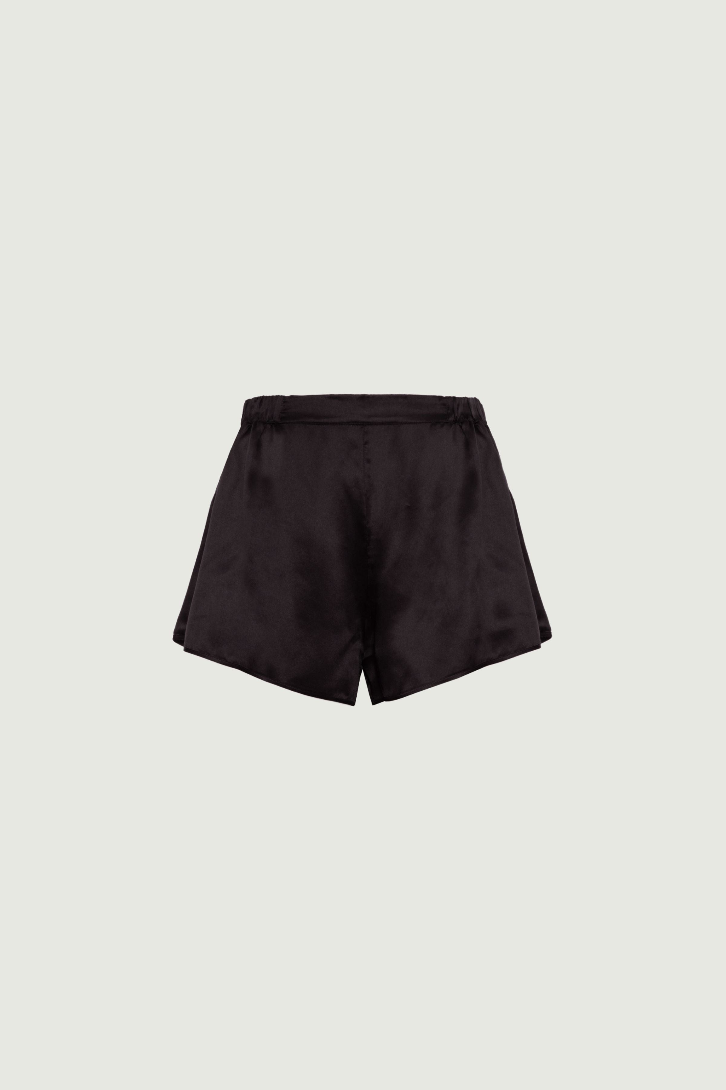 Black organic silk shorts with elastic waistband and relaxed fit, fluid silhouette and soft finish, front view
