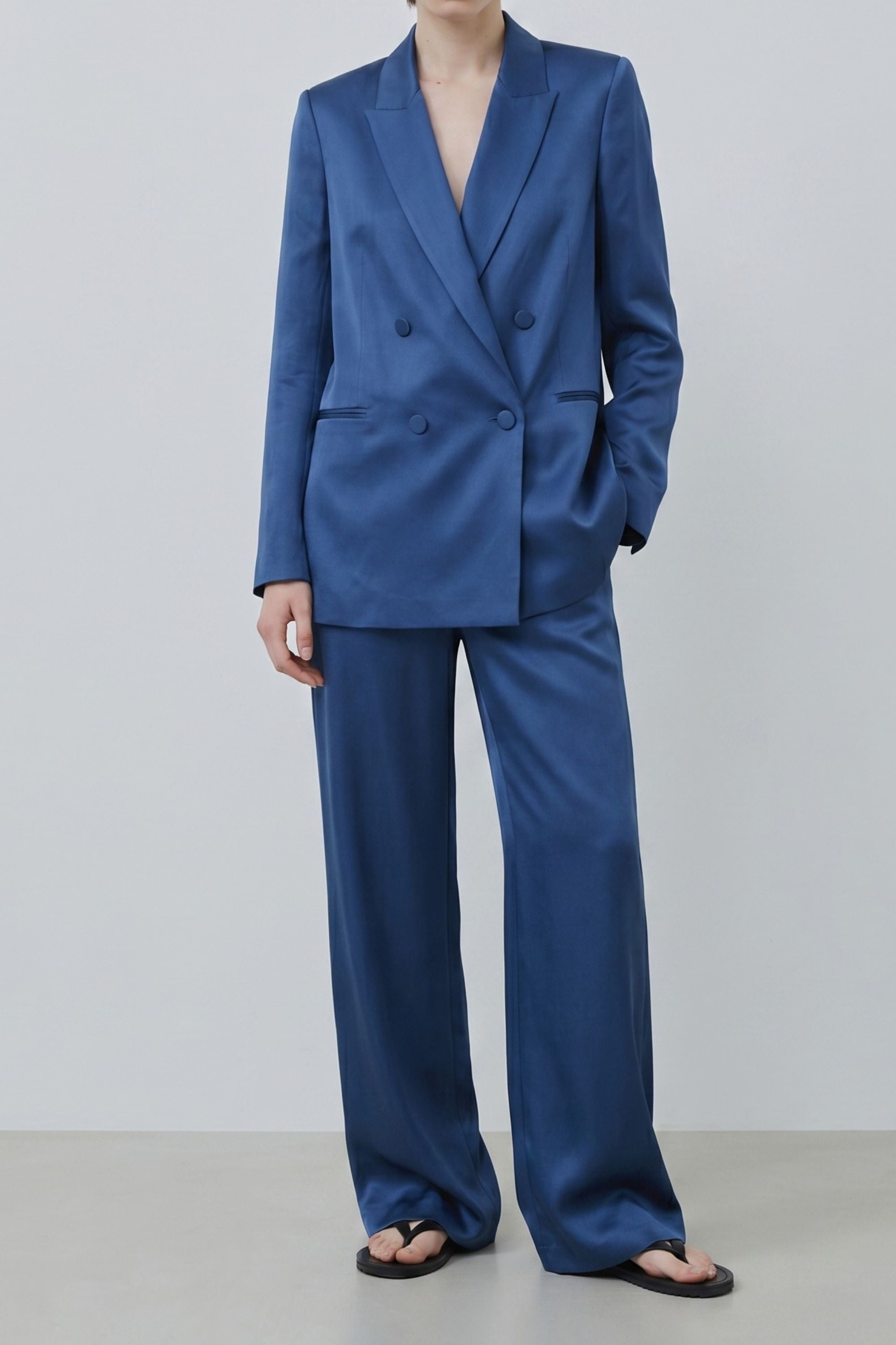 Organic silk wide-leg trousers in denim blue worn with matching blazer, made in Italy, fluid silhouette and breathable silk fabric