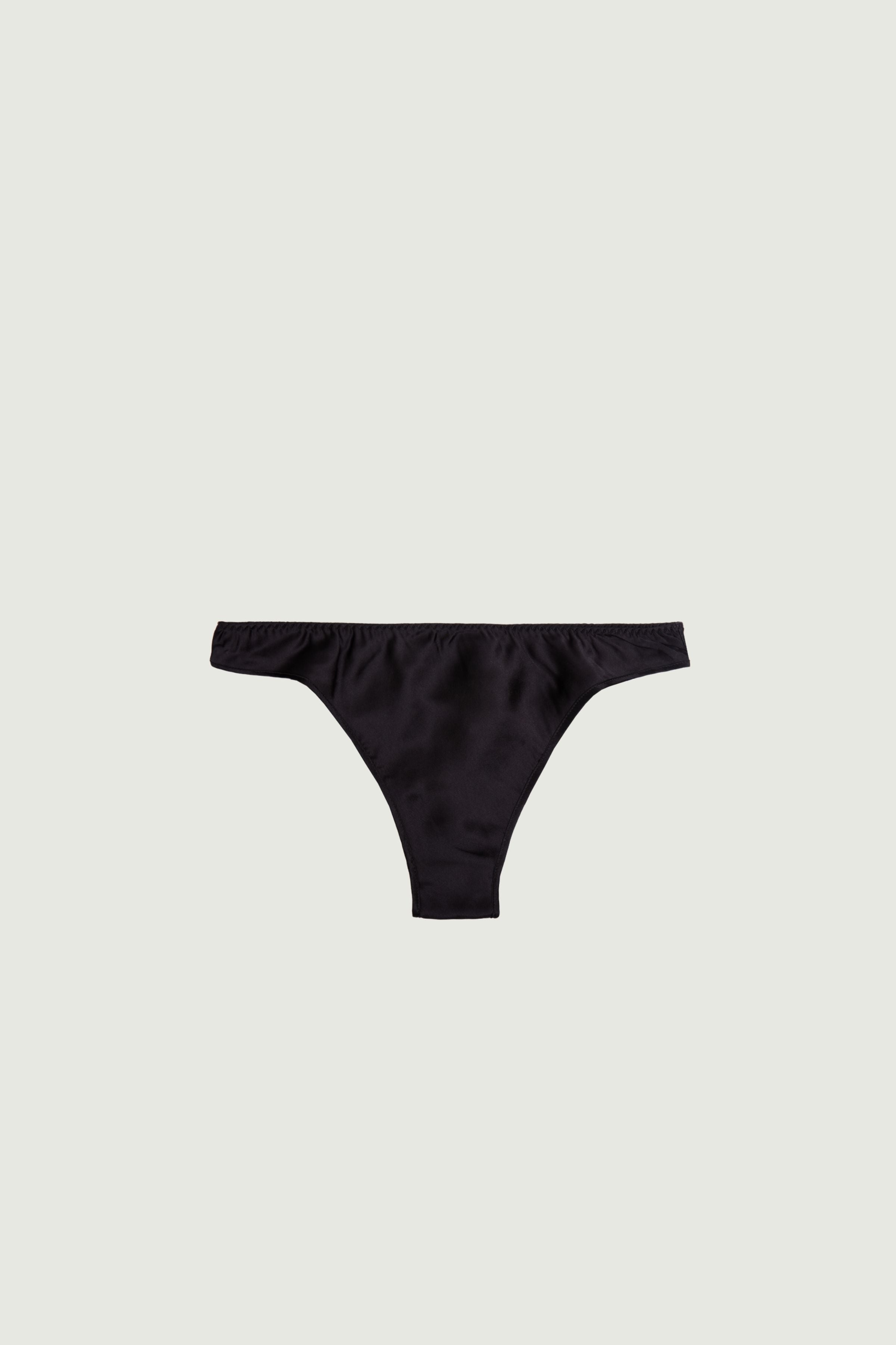 Black silk low-rise panty with minimal coverage, front view highlighting low-rise fit and clean horizontal line