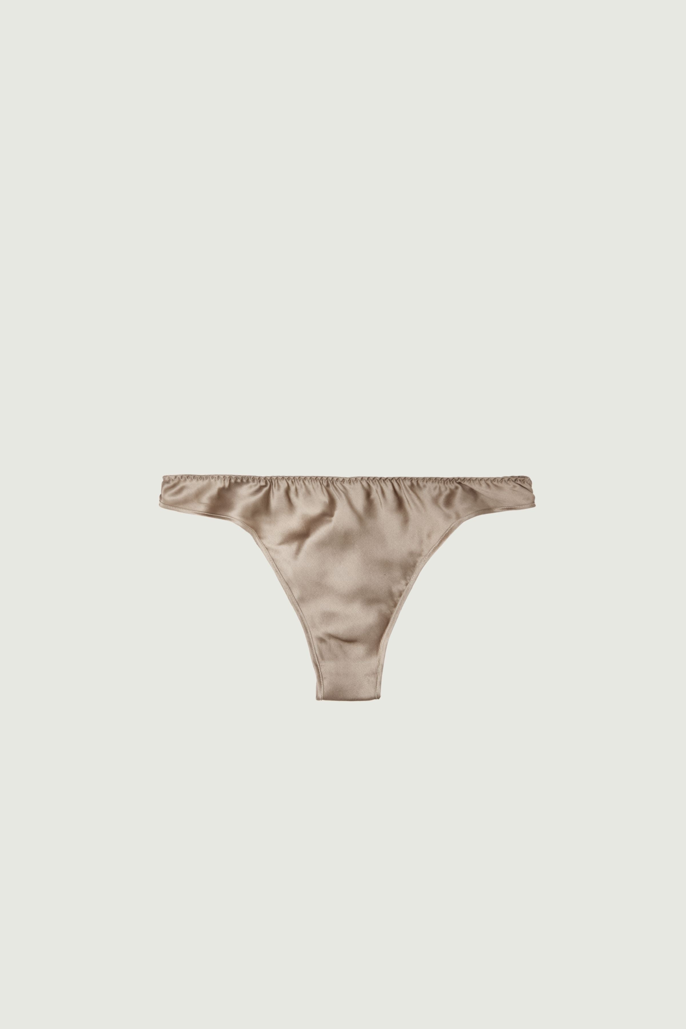 Gold sand silk low-rise panty with minimal coverage, front view highlighting low-rise fit and luminous neutral tone