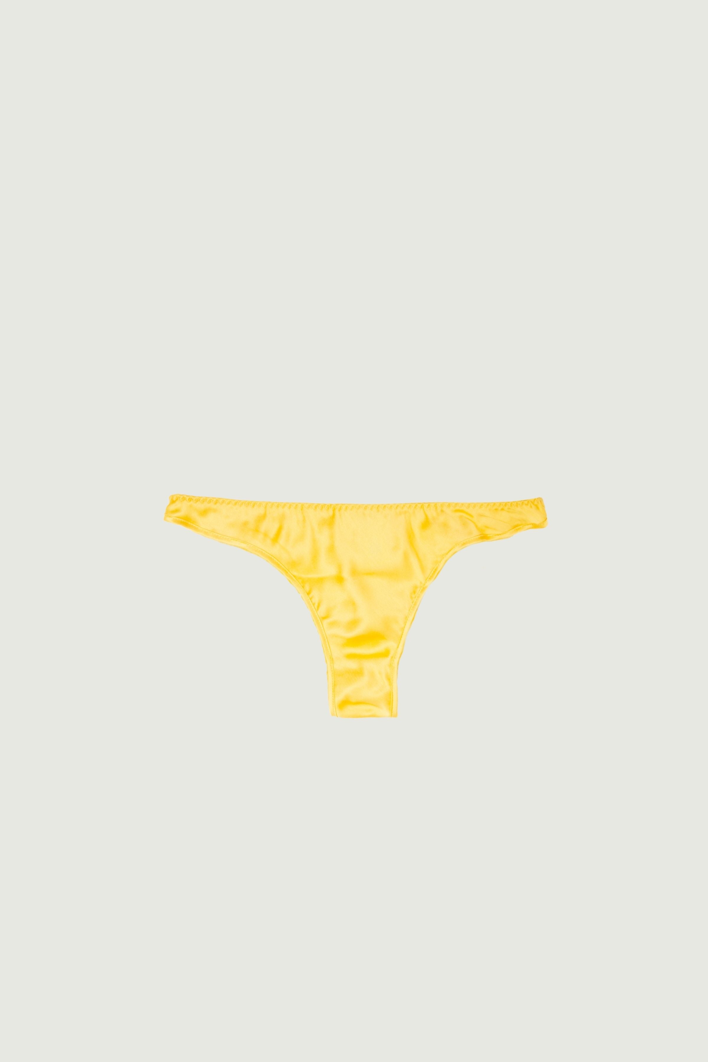 Mango silk low-rise panty with minimal coverage, front view highlighting low-rise fit and warm sunlit tone
